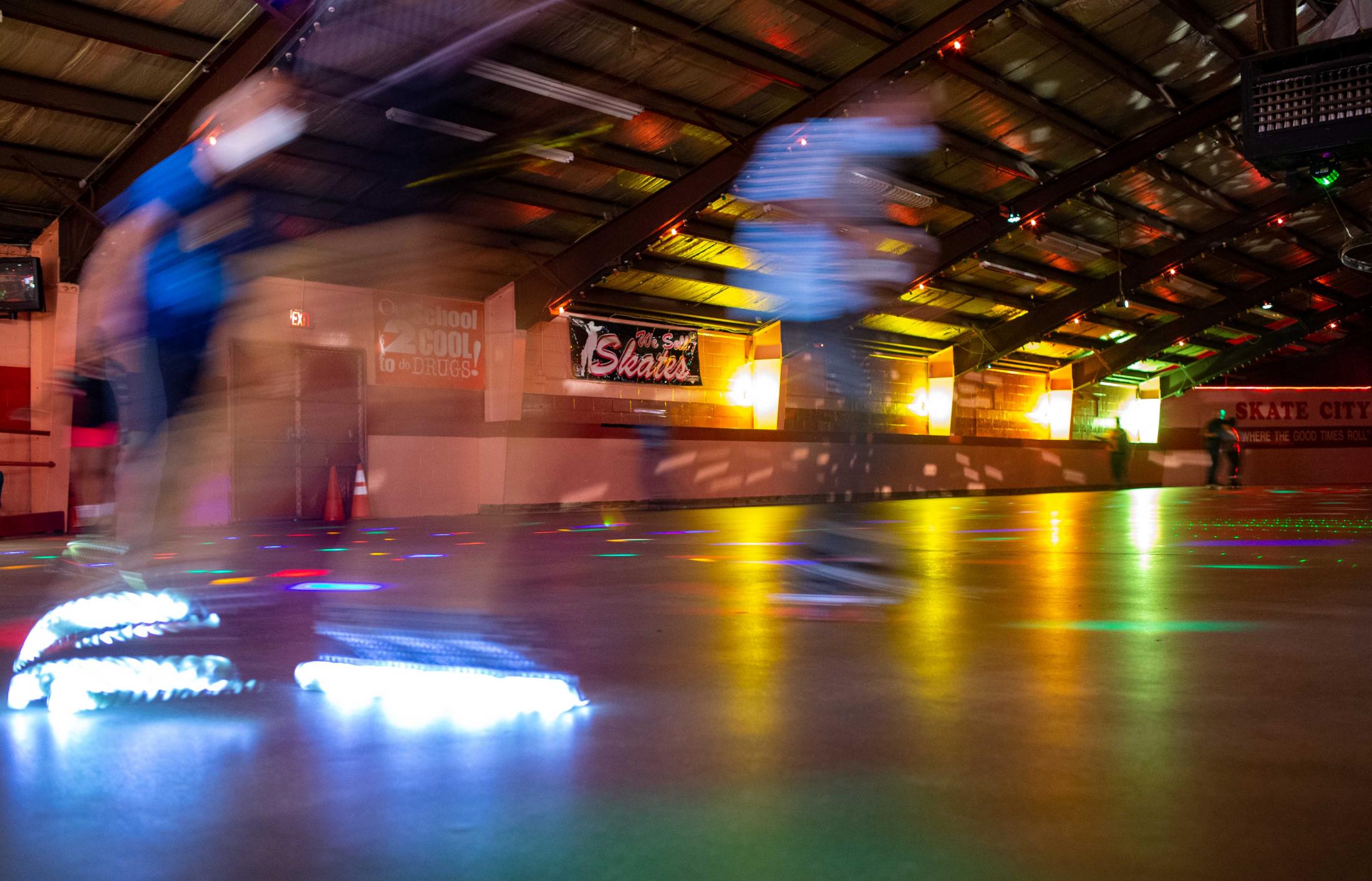 Skaters glide past the entrance to the skating rink at Skate City on Monday, July 12, 2021, in East St. Louis. Skate City is owned by Lawrence Wise, Sr., and his son Larry Wise, daughter Laura Wise and wife Patricia Wise also work with him at the skating rink.