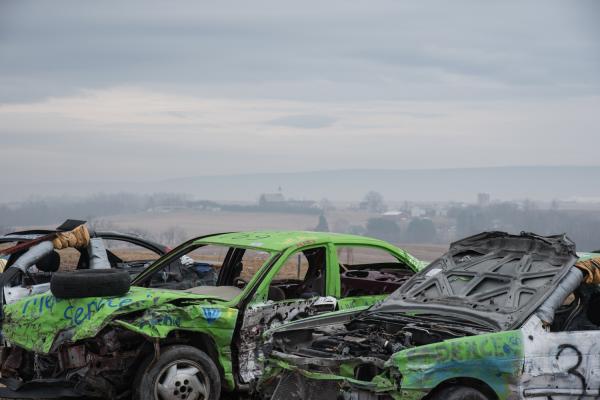 Home/Land -   Demo Derby cars parked, Lykens Valley in background  