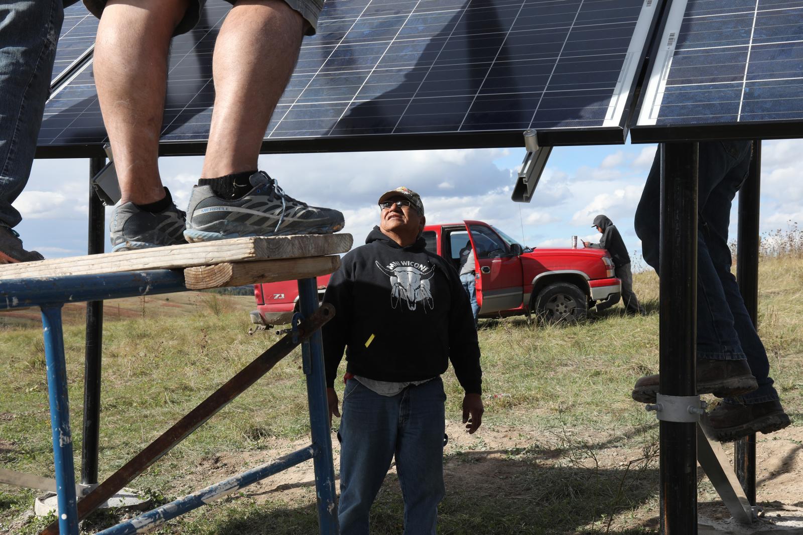 Ivan Looking Horse helps to install solar panels on the Pine Ridge reservation in South Dakota,...