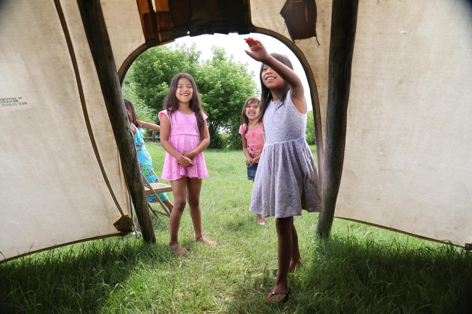 Solar Energy Warriors - Henry Red Cloud's granddaughters play in a teepee on...