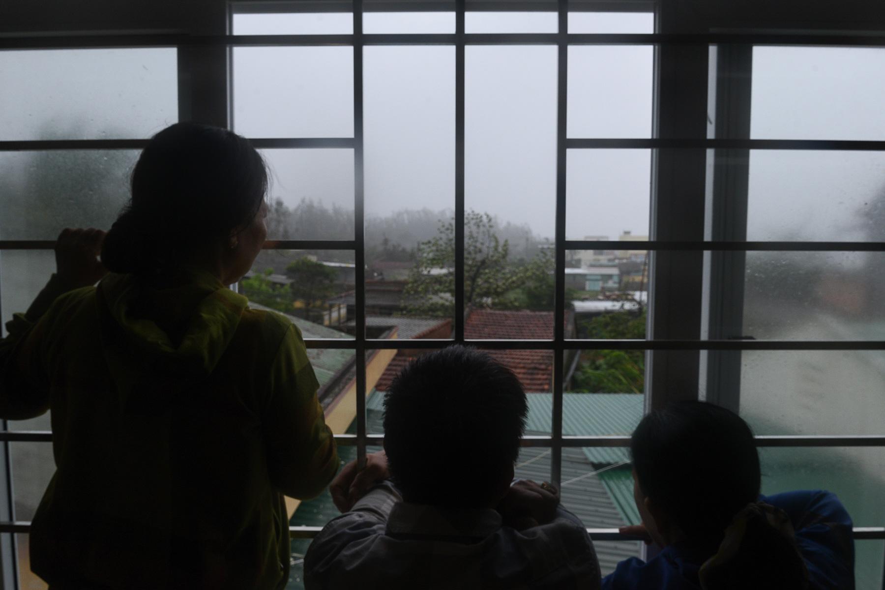 People look outside from a shelter as Typhoon Molave lashes Vietnam&#39;s coast in Binh Chau village, Quang Ngai province October 28, 2020.