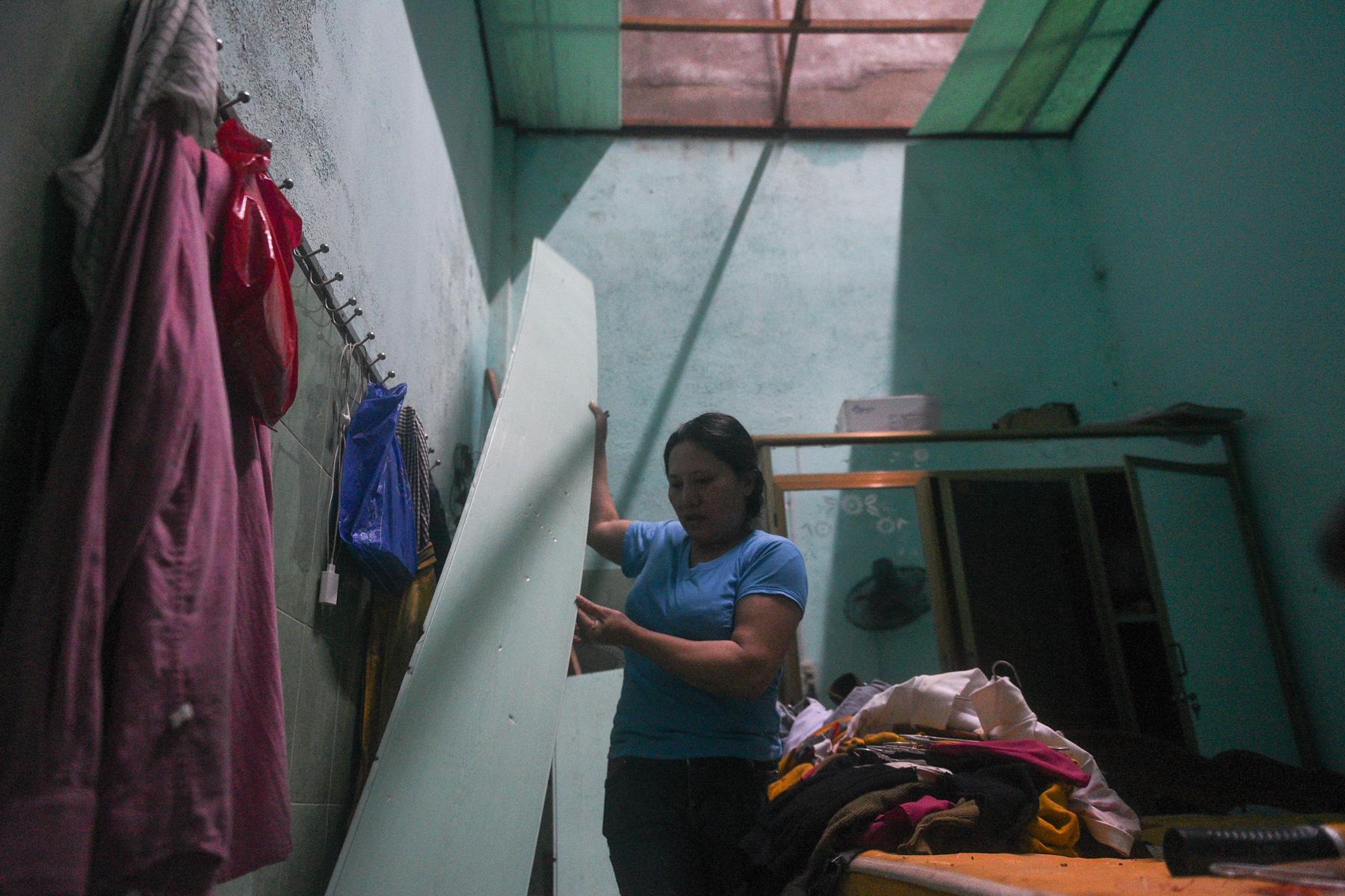 A month with full of sorrow - A woman stands in her house damaged by the Typhoon Molave...