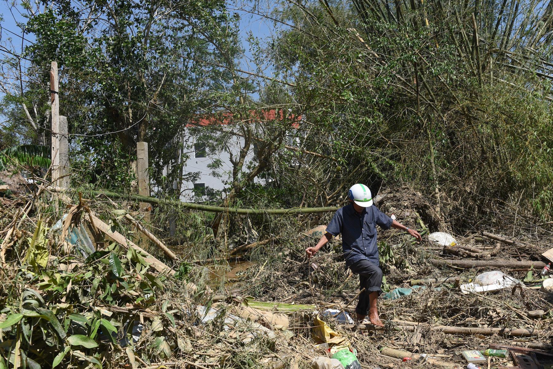A month with full of sorrow - A man walks on a road damaged by the Typhoon Molave in...