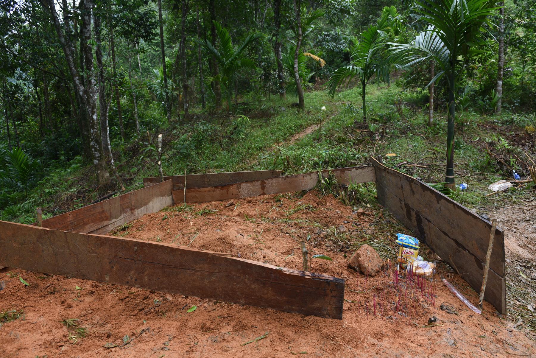 A month with full of sorrow - A makeshift grave for landslide victims is seen in Nam...