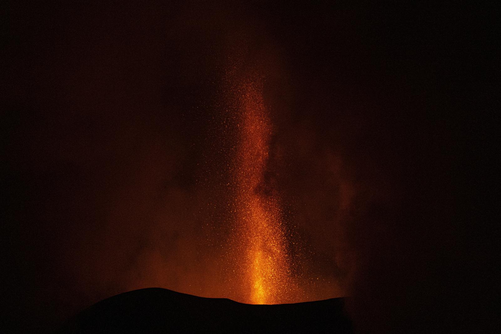 Under the cloud -  View of Cumbre Vieja volcano eruption at night. 