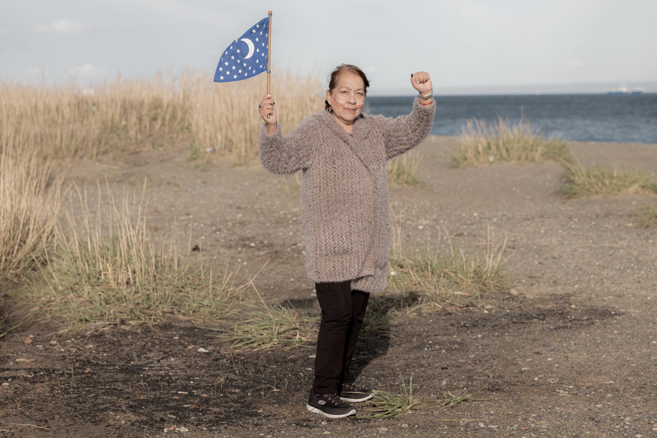 On the banks of the Strait of Magellan, Maria Margarita Vasquez Choque (Pilar) proudly holds the...