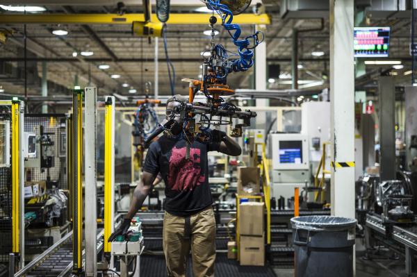 Image from Magna Factory - A Linamar worker assembles automotive parts at their LPP...