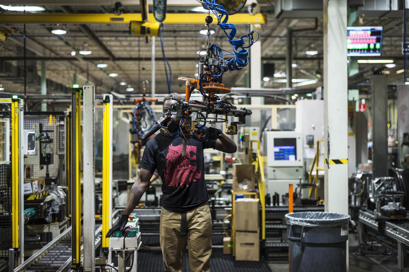 A Linamar worker assembles auto...Elkaim for the New York Times. 