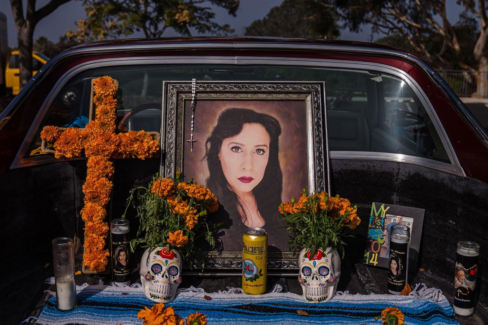 A photo of Sandra Ramirez is displayed in an altar in the back of a classic car at the 8th Annual Encinitas Day of the Dead Festival on October 30, 2021 in Encinitas, Calif.