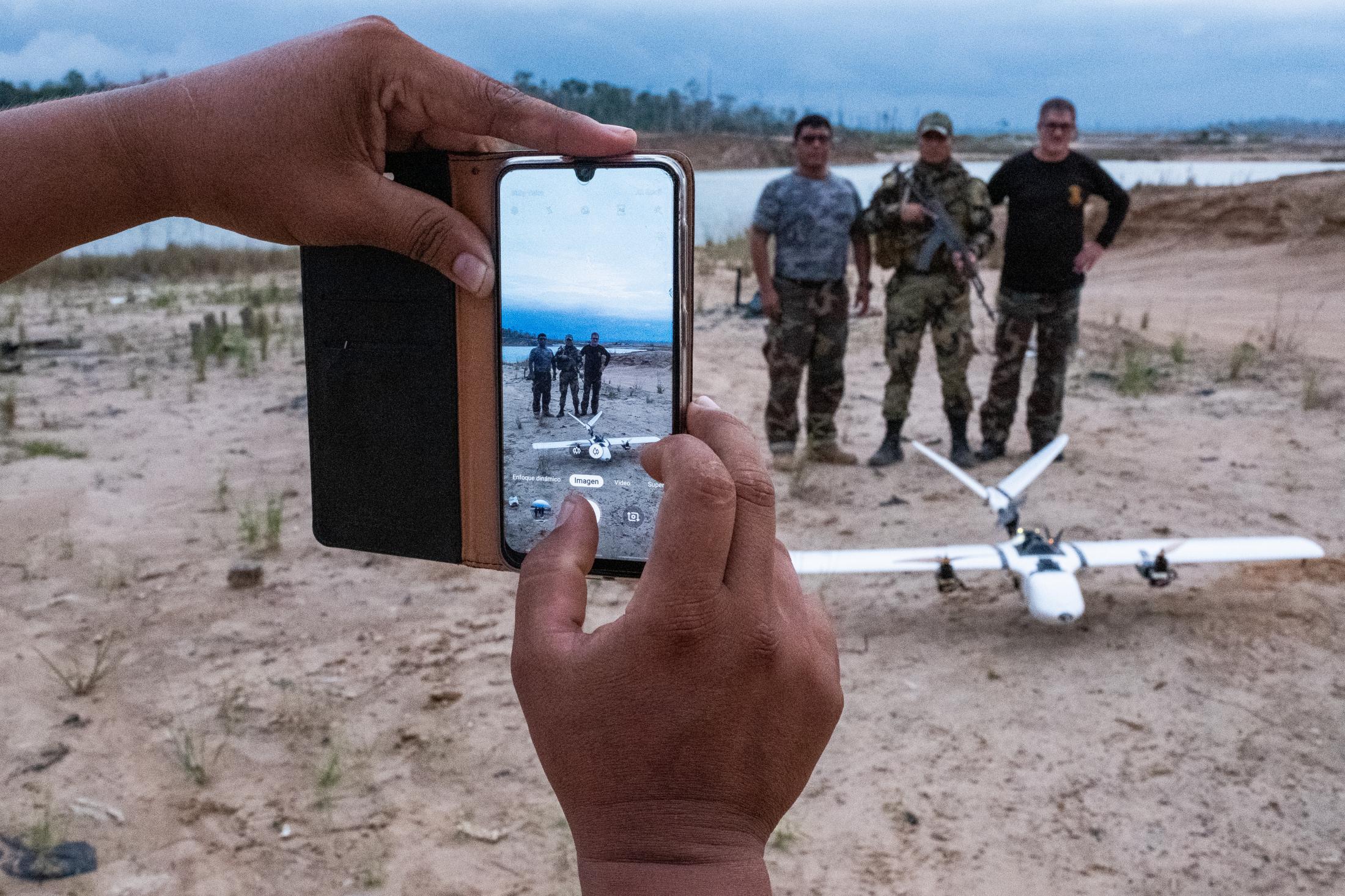 La Pampa's Illegal Gold Mining - Peruvian National Police Special Forces members from the Mega 12 base take a photo with...