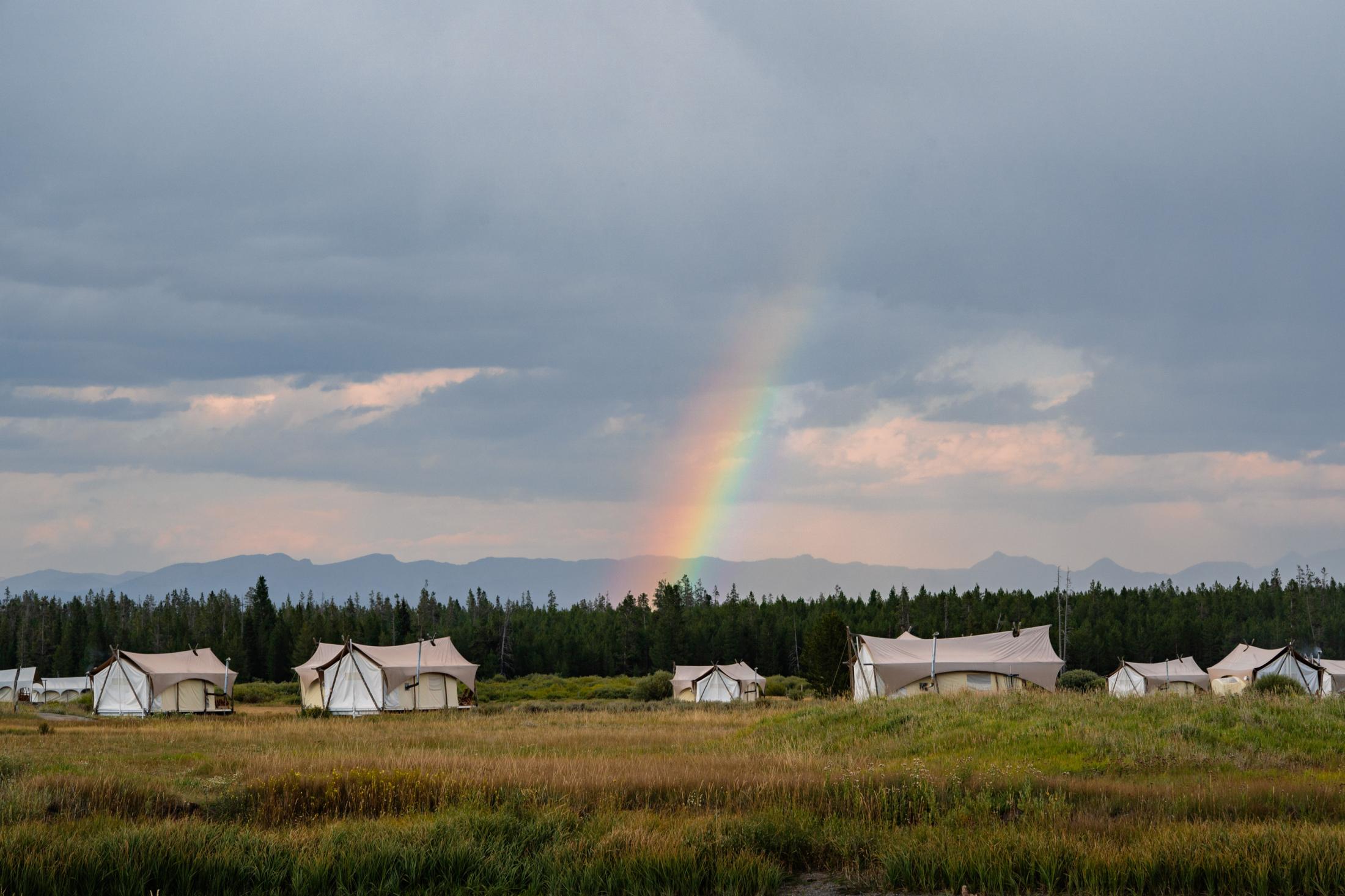 At Yellowstone National Park, I got to experience glamping for the first time. No WiFi, no shower in the tent, no heater. I was only able to warm myself with fire in the stove, but it was the best way to enjoy nature. At our glamping site, I see a rainbow casting in the forests.