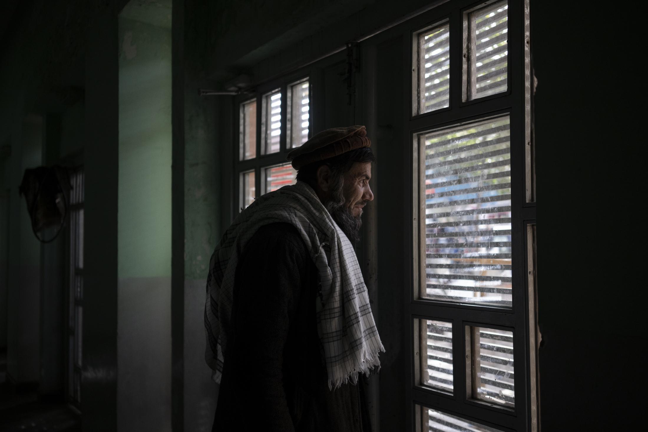 The Cinema of Kabul - Abdul Fatah looks out the window from the Ariana Cinema...