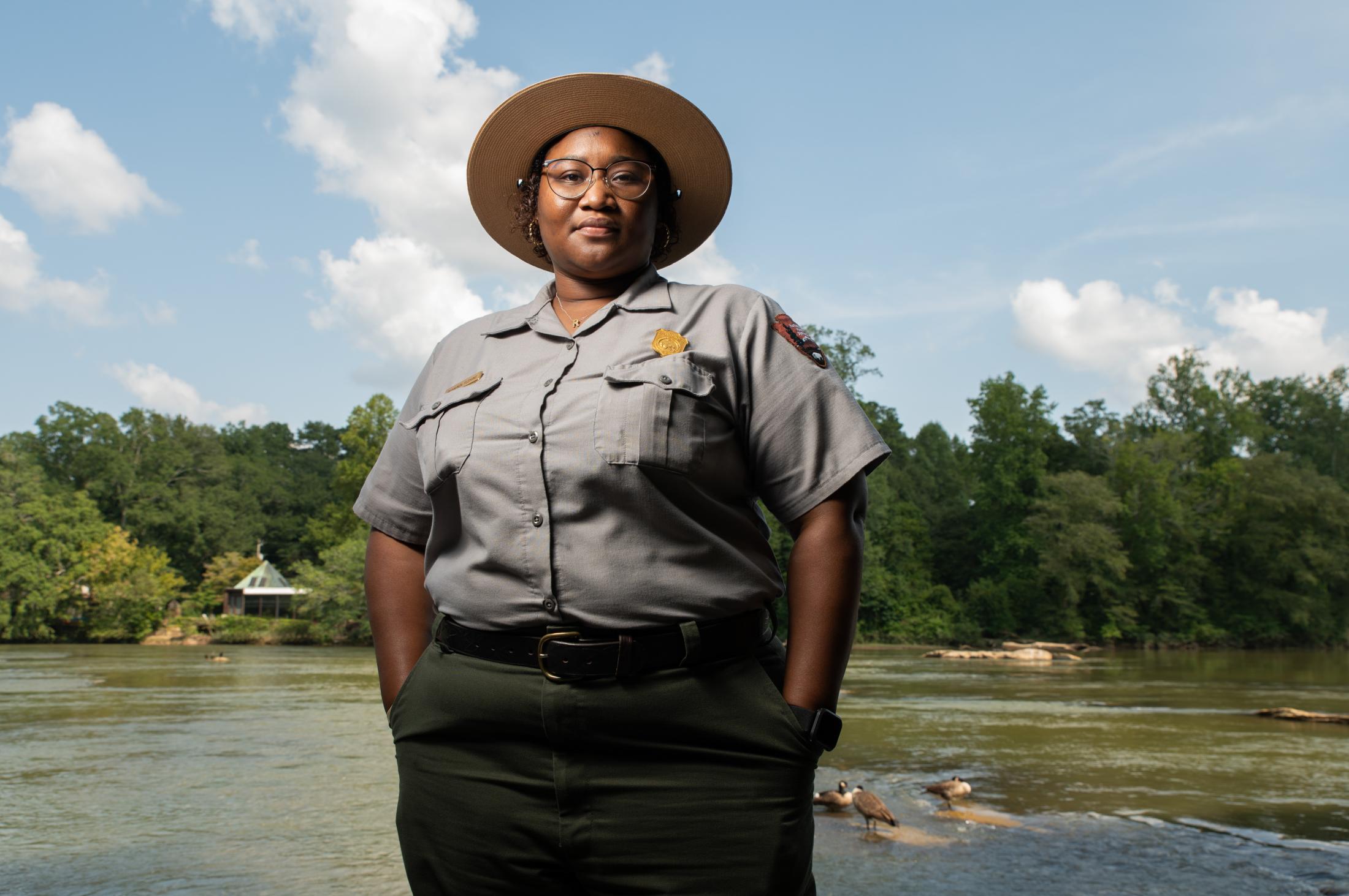  Rashaunda Fleming poses for a portrait at the Chattahoochee National Park Service headquarters. Working at the visitor center, Fleming sees people come to enjoy the park spanning 48 miles under Buford Dam. While the dam provides energy to families in metro Atlanta, dams can also exacerbate environmental damage by increasing water temperatures and encouraging invasive species, altering the natural ecosystem of the river. 