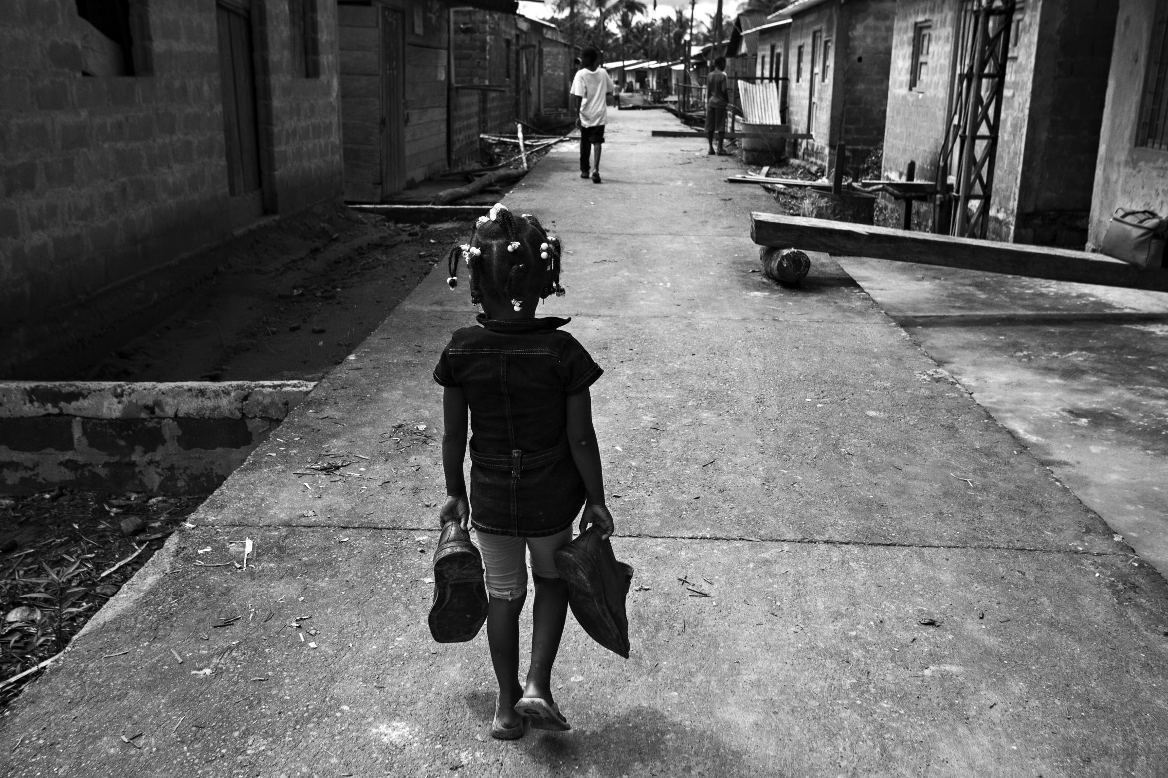 Forced Displacement in Chocó - Tanguí, Chocó, Colombia. A girl walks with...