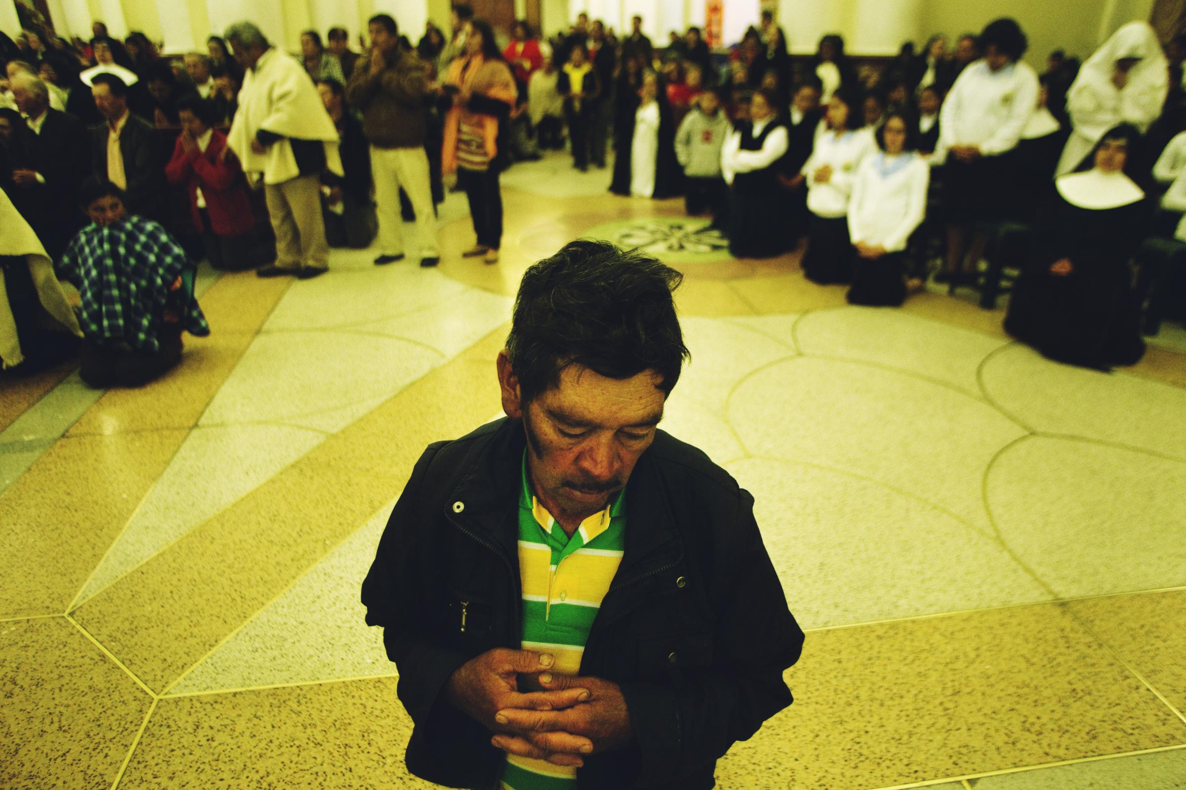 Boyacá - A man prays inside the Cathedral of Chiquinquirá,...