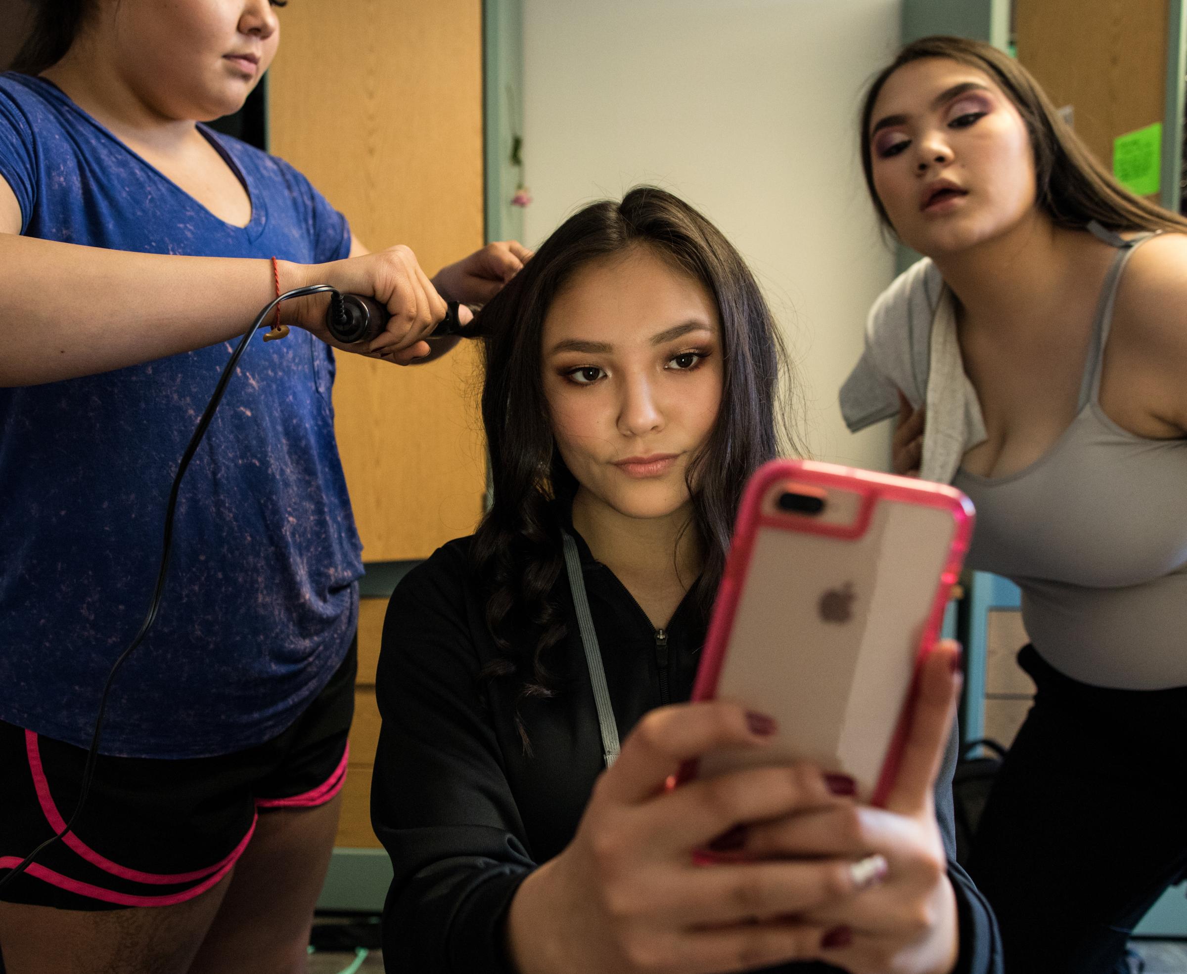 SITKA, ALASKA - SATURDAY, APRIL 7, 2018: Courtney Lestenkof takes a selfie while Claire Greene,...