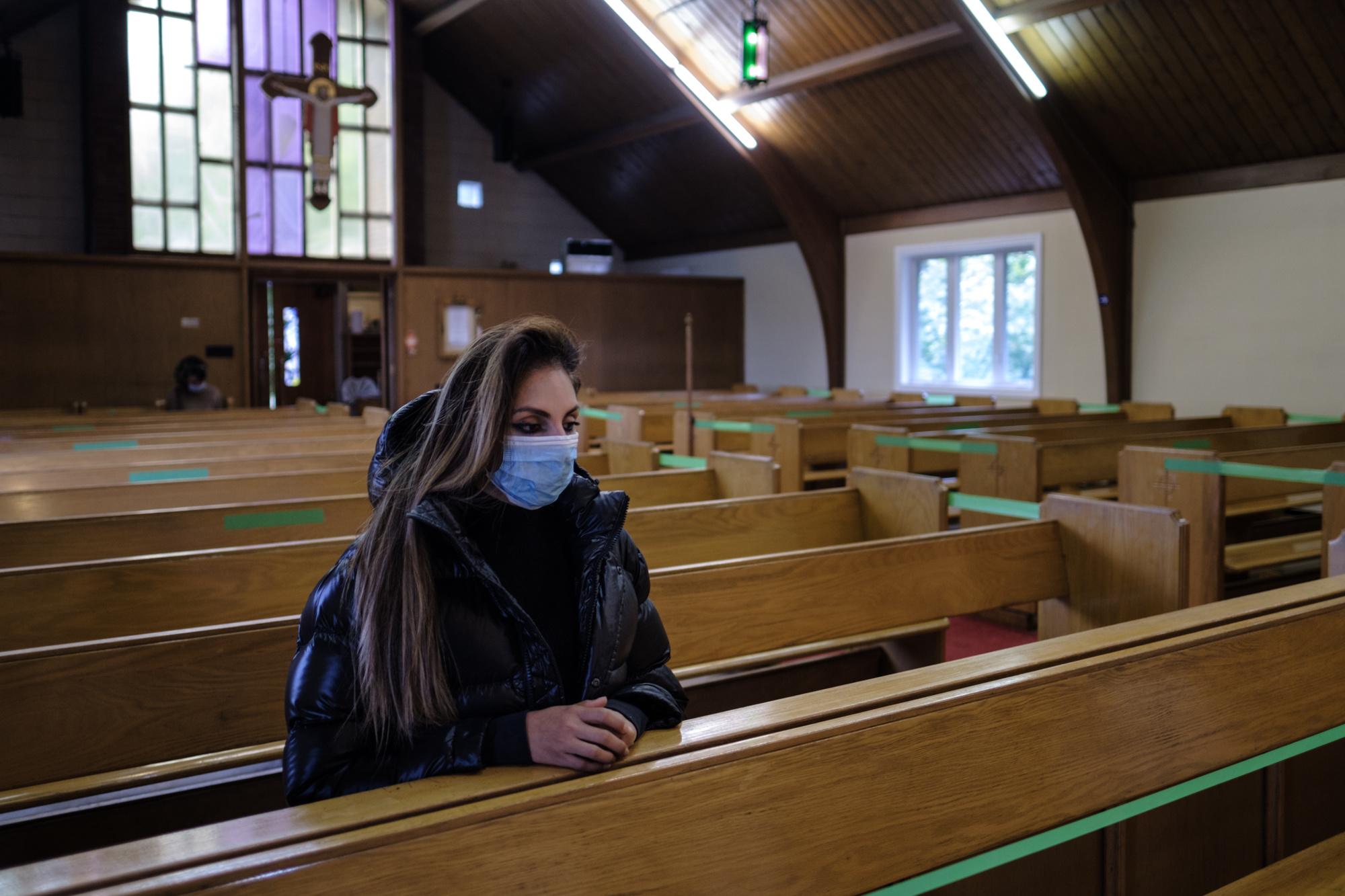 A Congregation Apart - A lone parishioner attends a Sunday service at San...