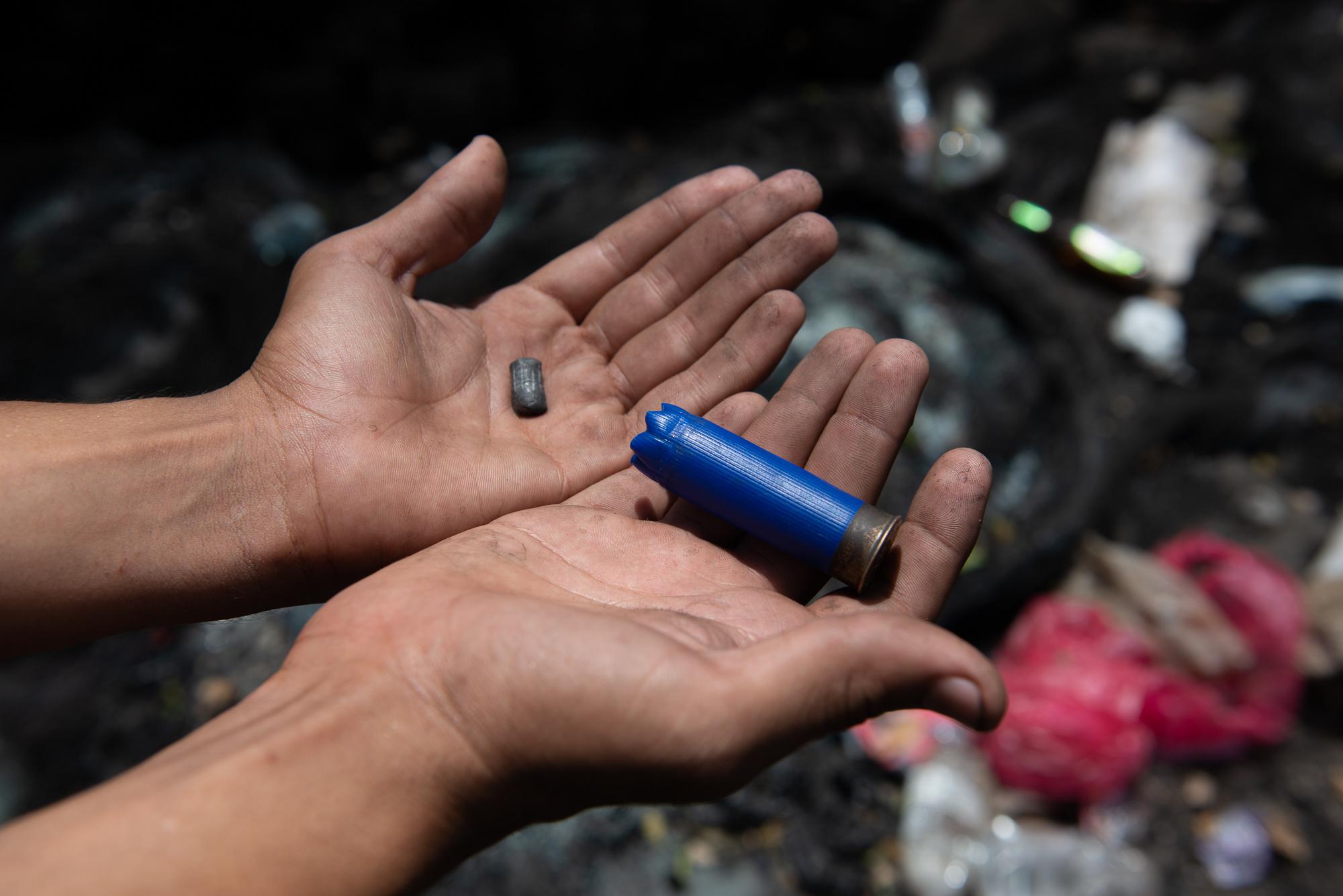SOS Nicaragua - A protestor shows off spent shotgun shells fired by...