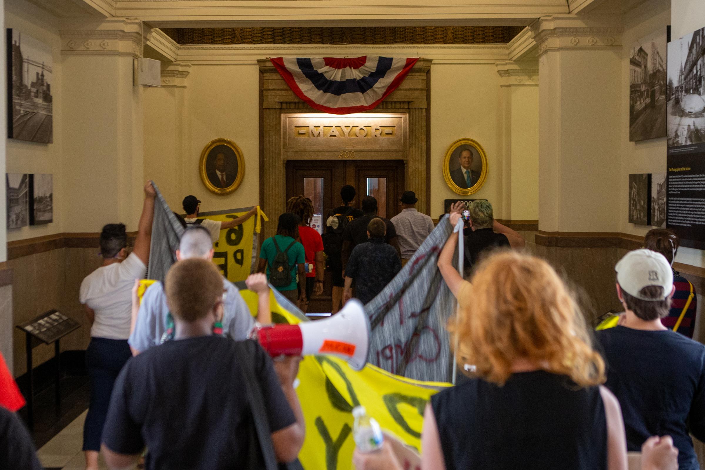 News - Protesters march to the Mayor's Office inside City...