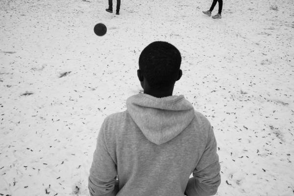 Banjul to Biella - Baba, from Senegal, plays football with Malick, from Gambia, and Mohammed, from Mali, on a field...