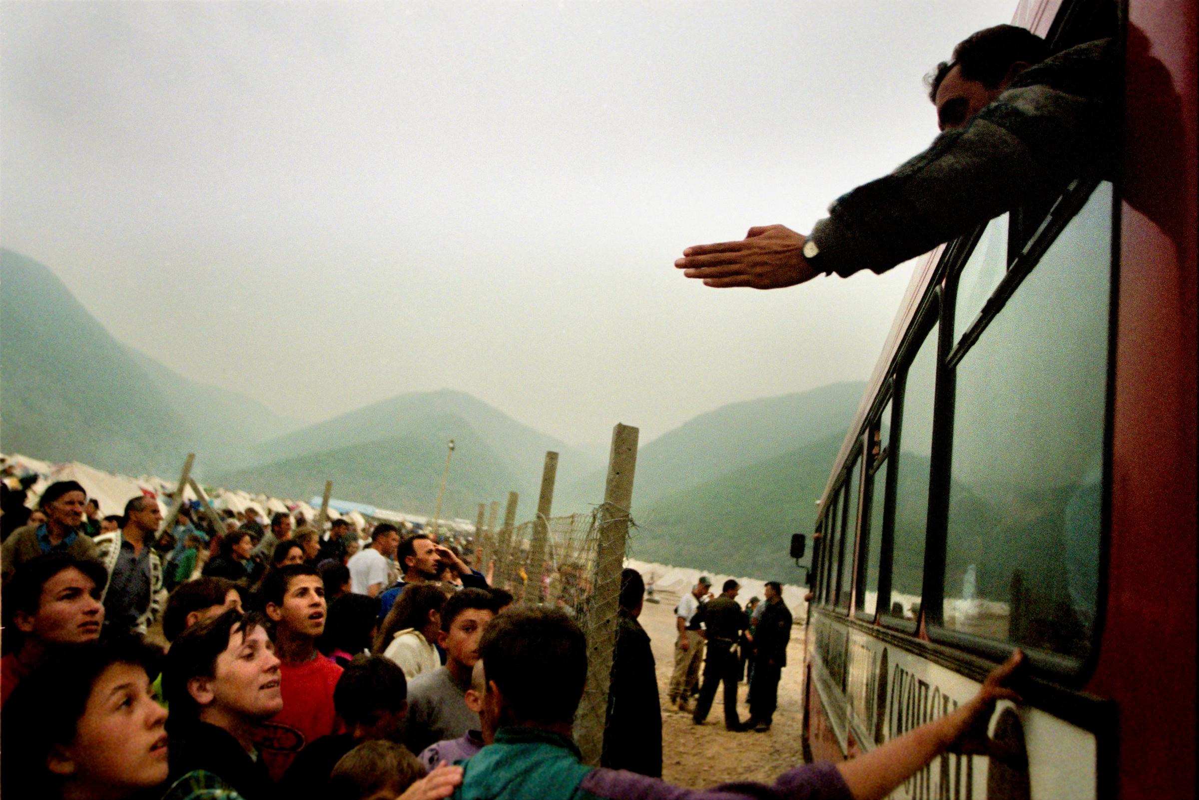 Flight From Kosovo - Refugees from the Cegrane camp crowd around buses...