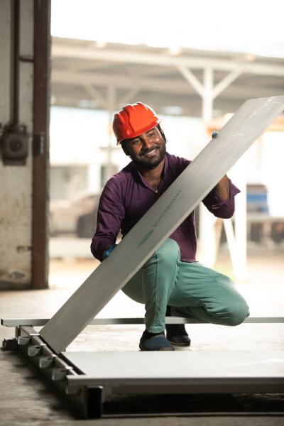 AEHMDABAD, GUJRAT, INDIA, (28/12/2021)- Photograph of Asif Ansari an employee of Re-Materials where he shows/demonstrates assembling the panel . Re-Materials designs and manufactures roofs which are eco friendly as it is made from Bio Plastic, Recycled Plastic and Cellulose composite which makes the roof drier in the monsoon season and up to 18 degrees Fahrenheit cooler in the summer. These roofs are also cost efficient addressing the needs of 16 million Indians. 