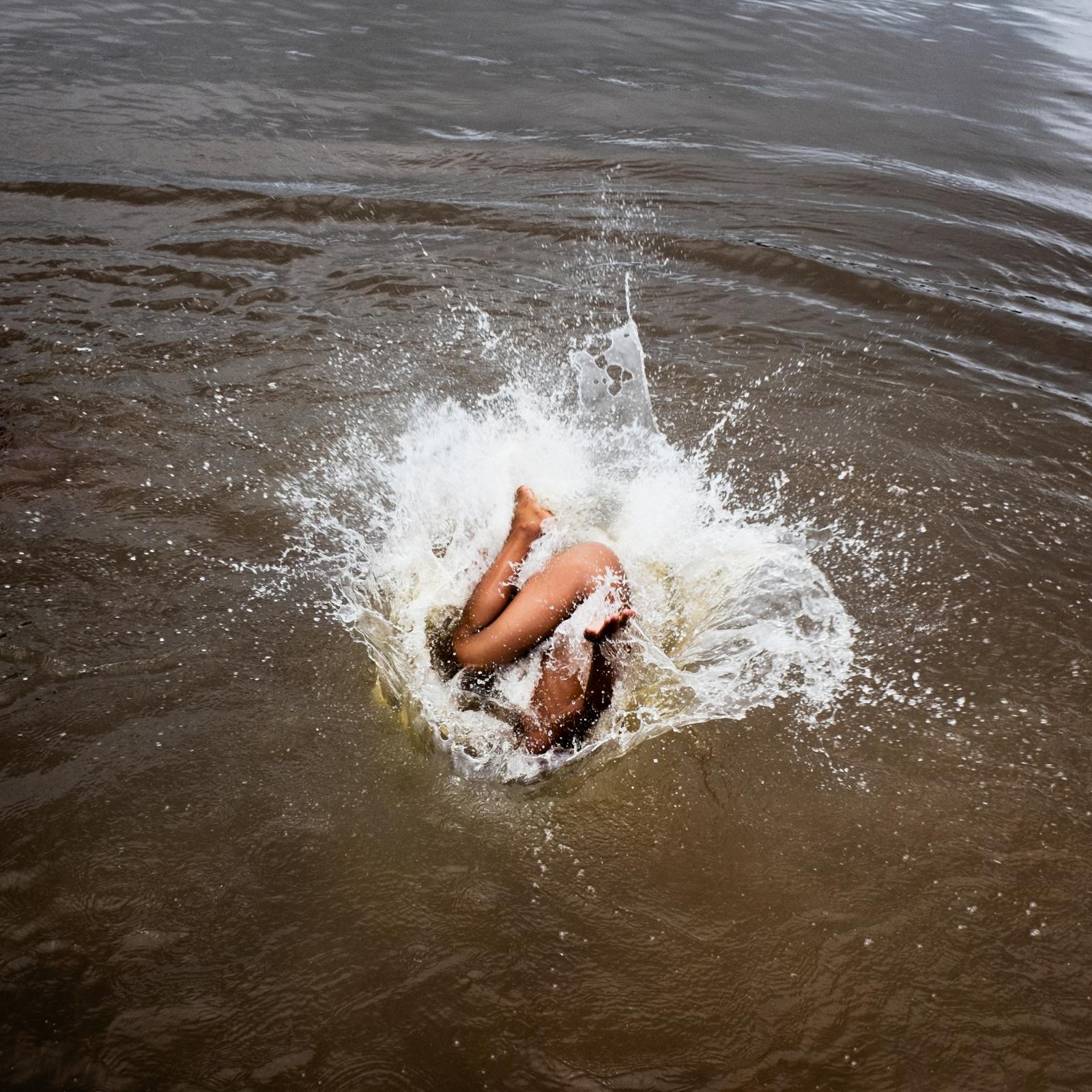 A child from the Xikrin village of &quot;Pot cr&ocirc;&quot; jumps into the Rio Bacaja, its name meaning &quot;the water that runs in river is the same as the blood that flows through our veins.&quot; Brazil. 2014 