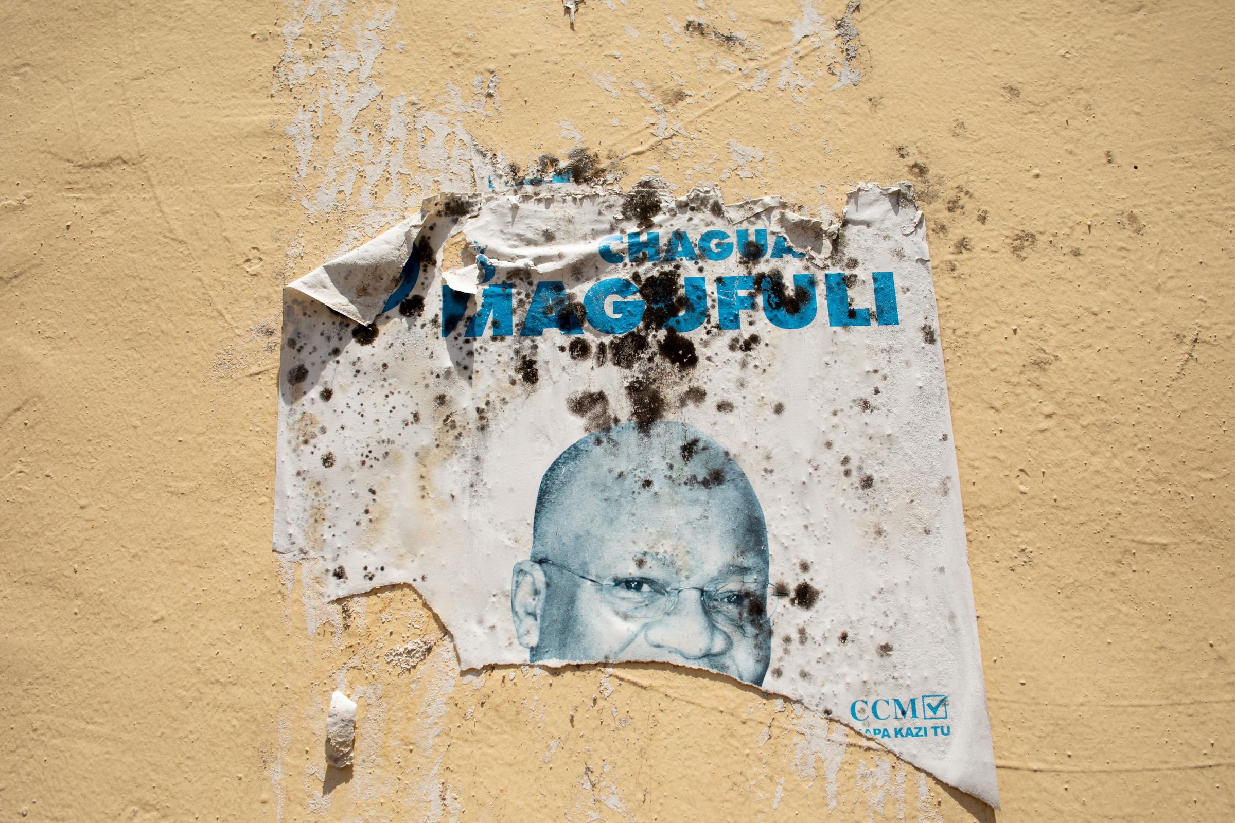 Covid Coverup - Worn and torn posters of ex-president John Magufuli, who died in March 2021, adorn walls across...