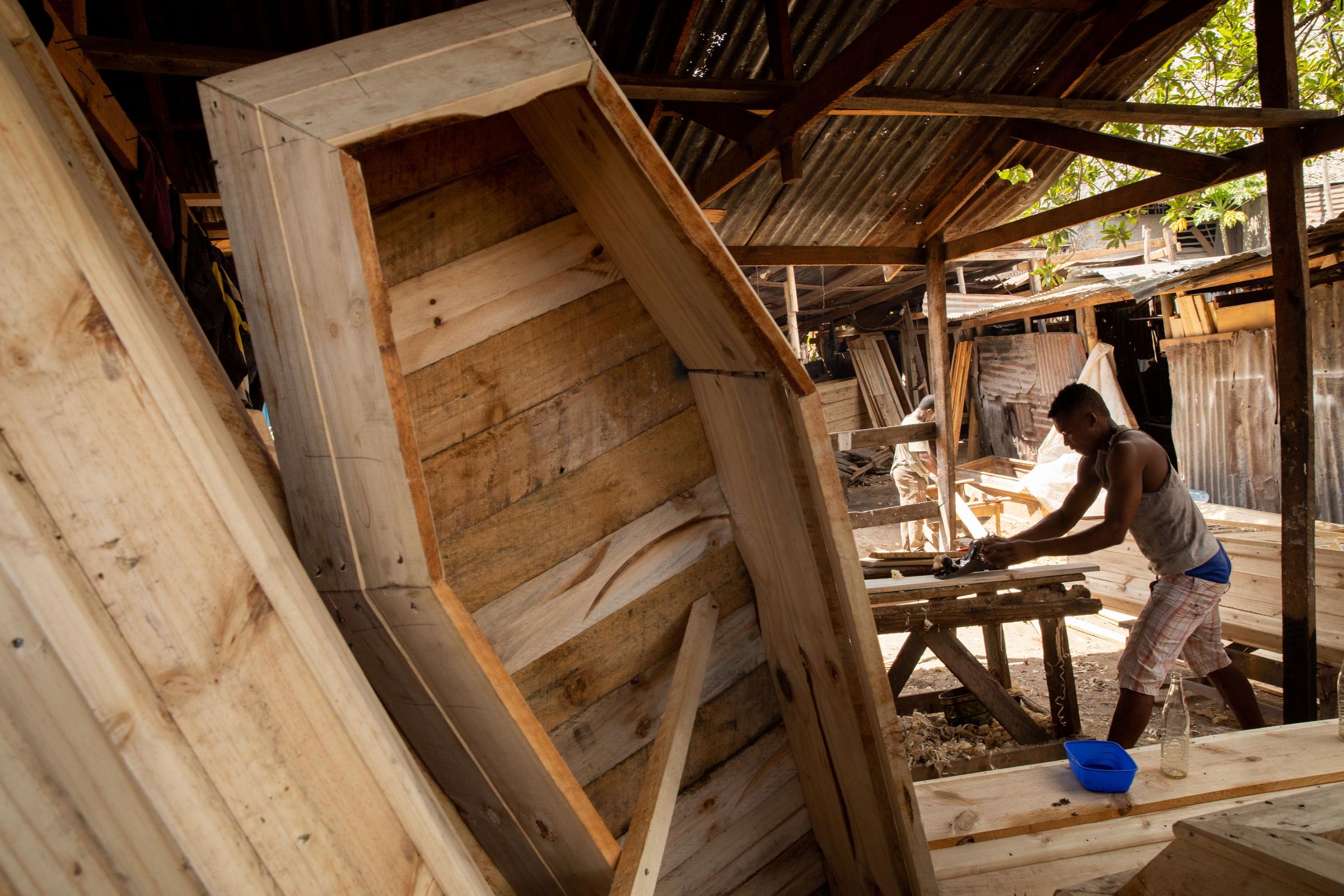 Covid Coverup - China Libabu makes a coffin in the Manzese district of Dar Es Salaam, Tanzania on 27 October...