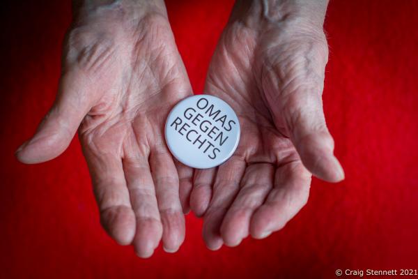 BERLIN, GERMANY- MARCH 24: A member of Omas gegen Rechts (Grannies against the Right) shows the badge worn by all of the groups supporters and members. The initiative Omas gegen Rechts was founded in Vienna in 2017 by journalist Susanne Scholl and Monika Salzer, a retired pastor. Salzer said that it was in response to the coalition of the Austrian People&#39;s Party and the Freedom Party of Austria during the first Kurz government. A German initiative of Omas Gegen Rechts was founded in 2018 initiated by former teacher Anna Ohnweiler. (Photo by Craig Stennett/Getty Images)