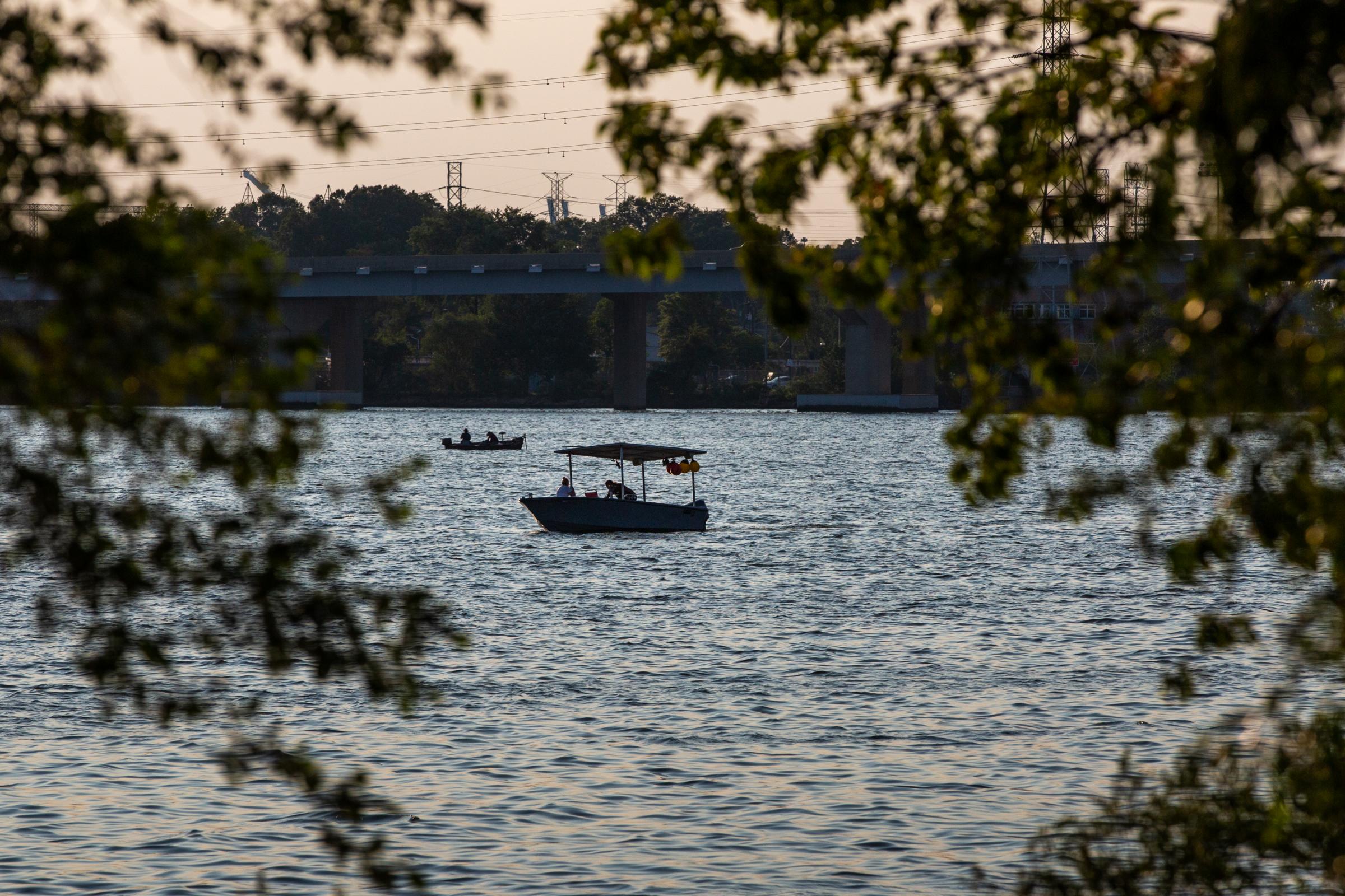 A crabbing boat floats along Bear Creek at sunset on August 5, 2021. The Environmental Protection Agency hopes to list parts of Bear Creek as a national Superfund site due to extensive contamination from years of toxic run-off from the former Bethlehem Steel Mill which was located along the creek on Sparrows Point.