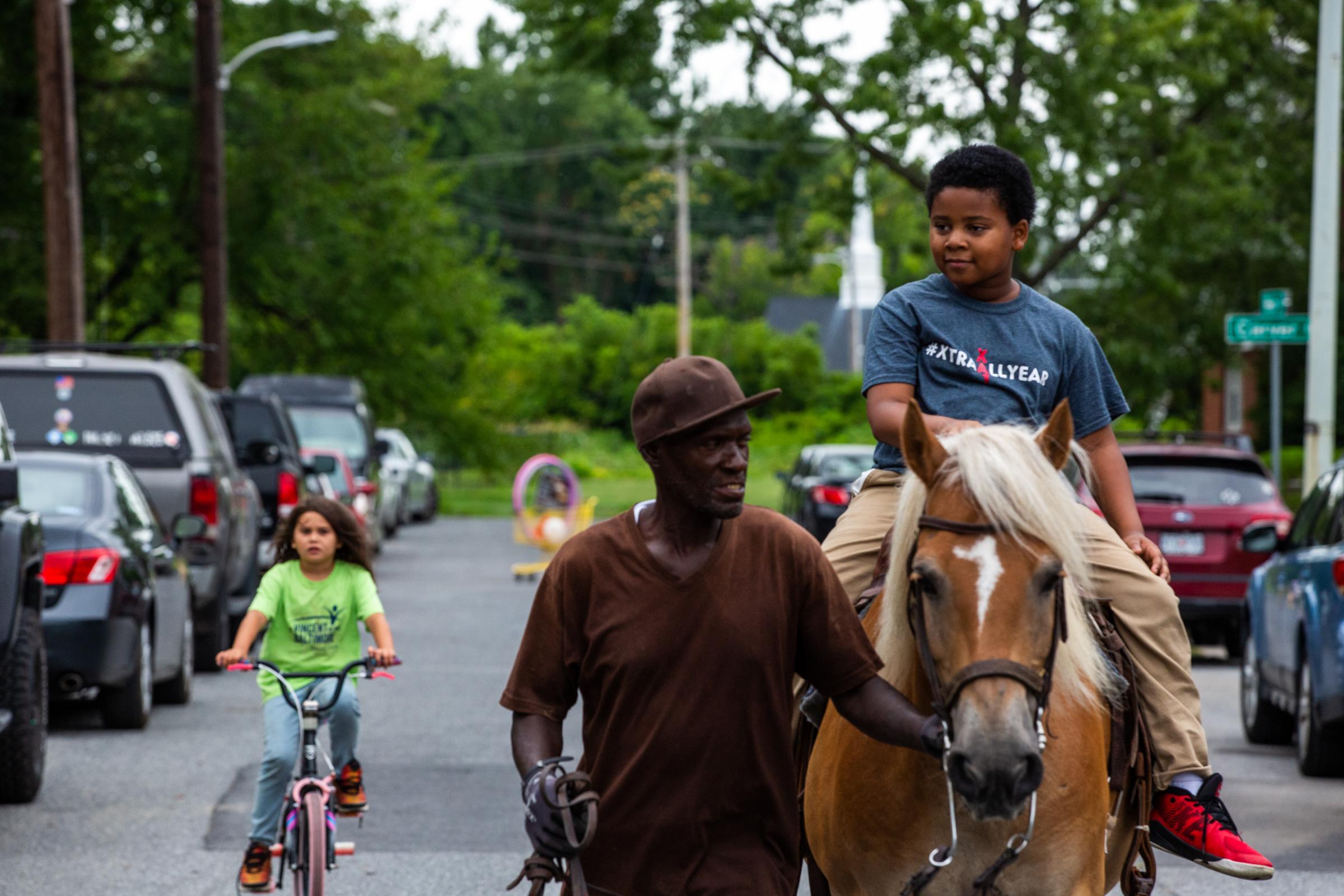 Turner Station: Heart and Soul - Jeremiah Dixon, 10, rides a horse down Main Street on...