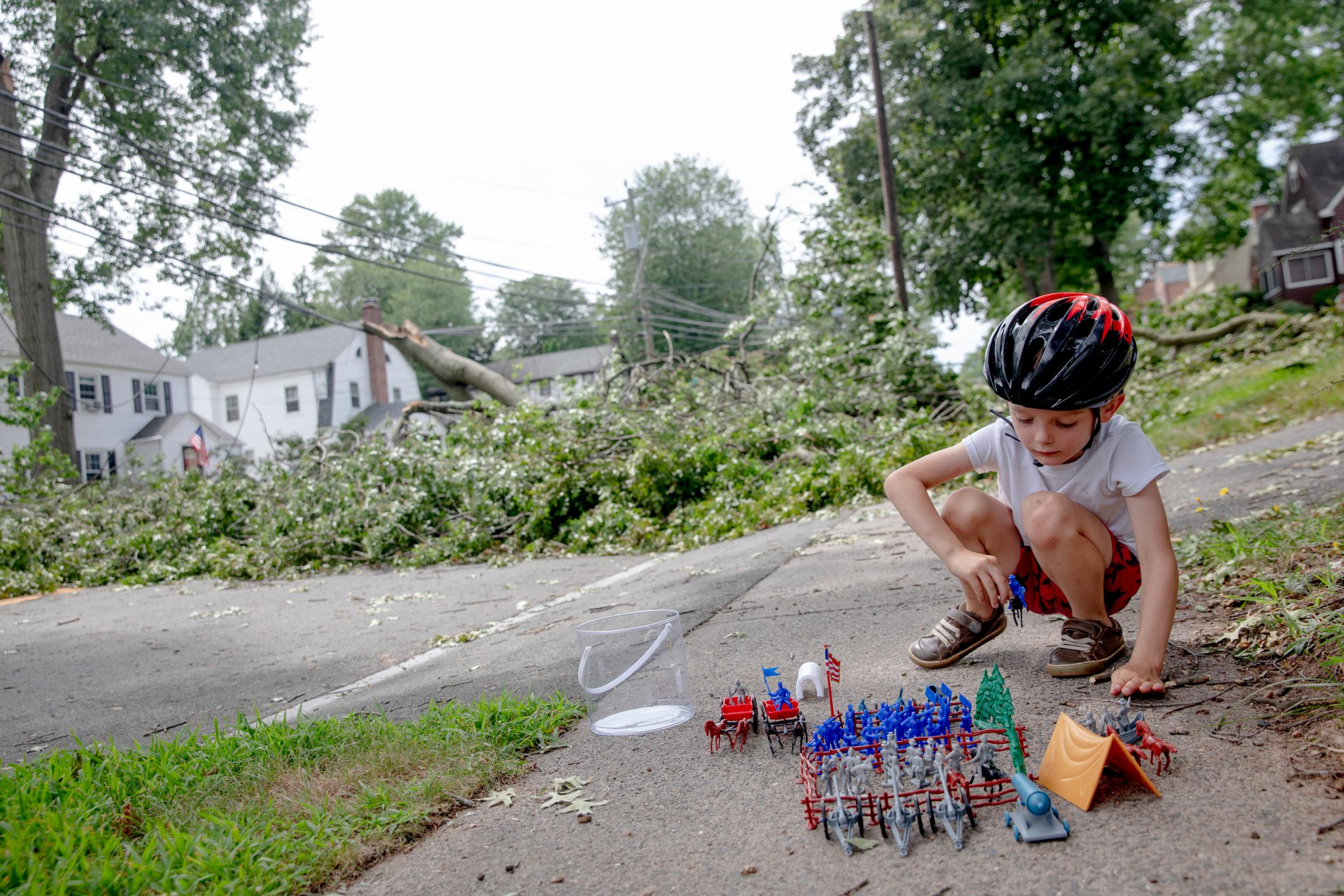 Leif Sondeen, 6, hangs out next to a blocked car road after Tropical Storm Isaias hit his neighborhood in West Hartford. Leif also rode a bike on...