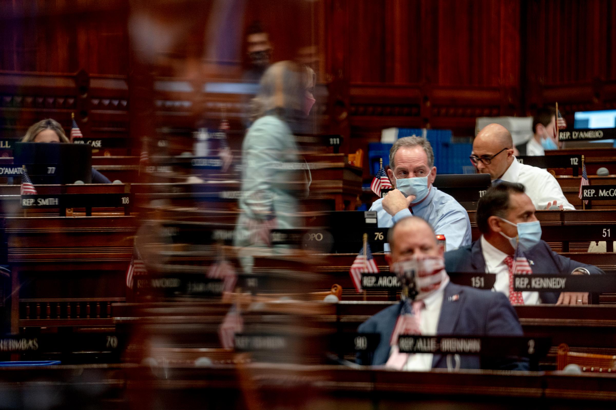 Singles - Lawmakers are viewed through a plexiglass barrier while...