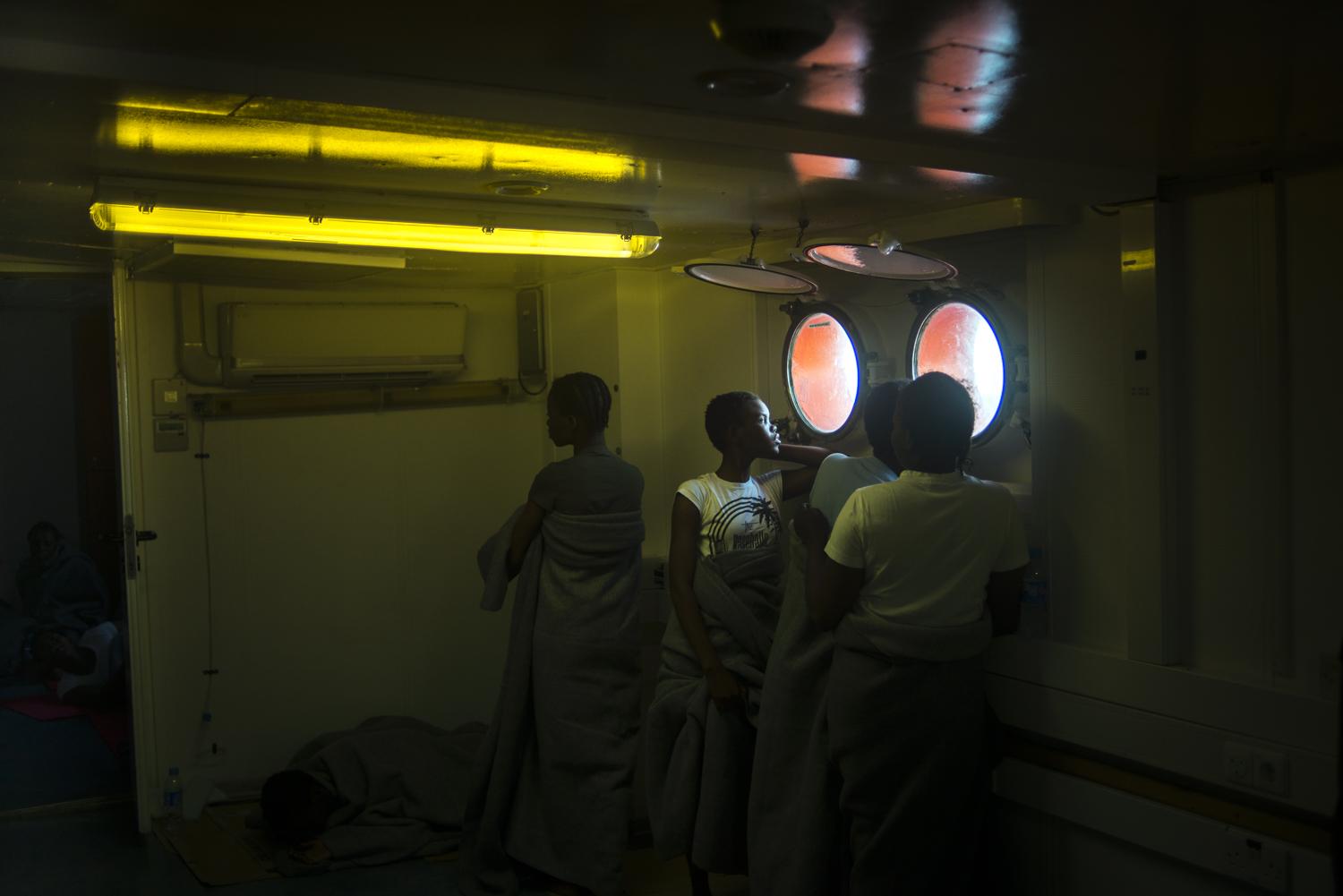 Humanitarian rescue operations in the Mediterranean Sea, by the European civil organization Sos Méditerranée in partnership with Médecins du Monde: Onboard, West African women have a rest and meditate looking throw the Mediterranean