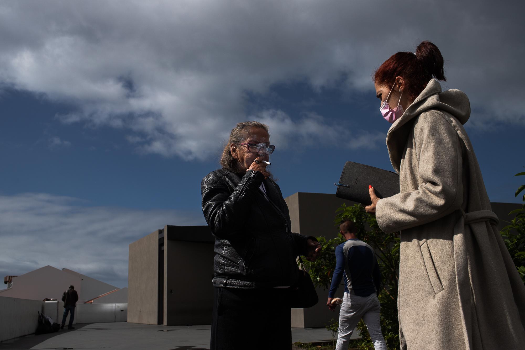 Accompanied by a social worker, Evelina smokes a cigarette in front of Novo Dia&rsquo;s...