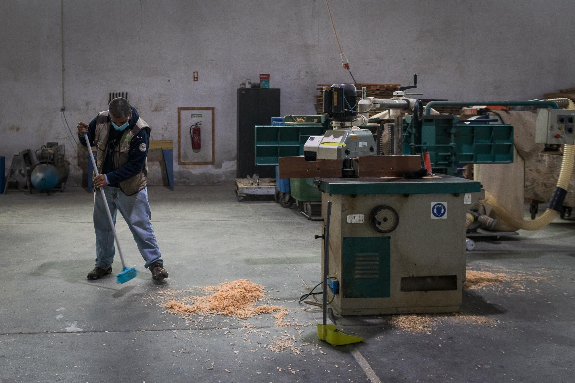Jos&eacute; Pacheco brooms the floor of the carpentry where he works in Lagoa, Azores,...