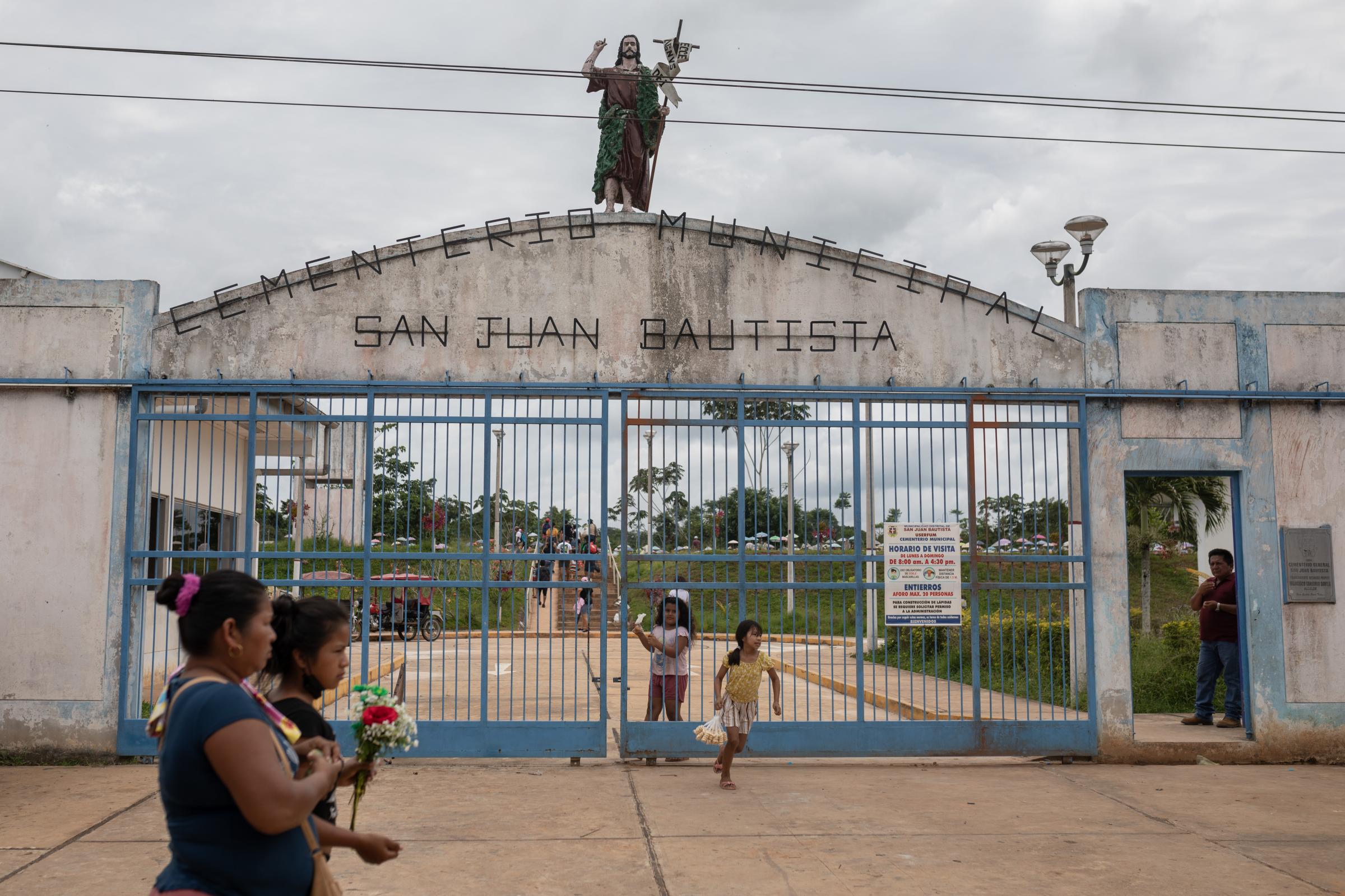 Vaccinators in Peru's Amazon are challenged by religion, rivers and a special tea - People visit the San Juan Bautista cemetery in Iquitos, Peru.
