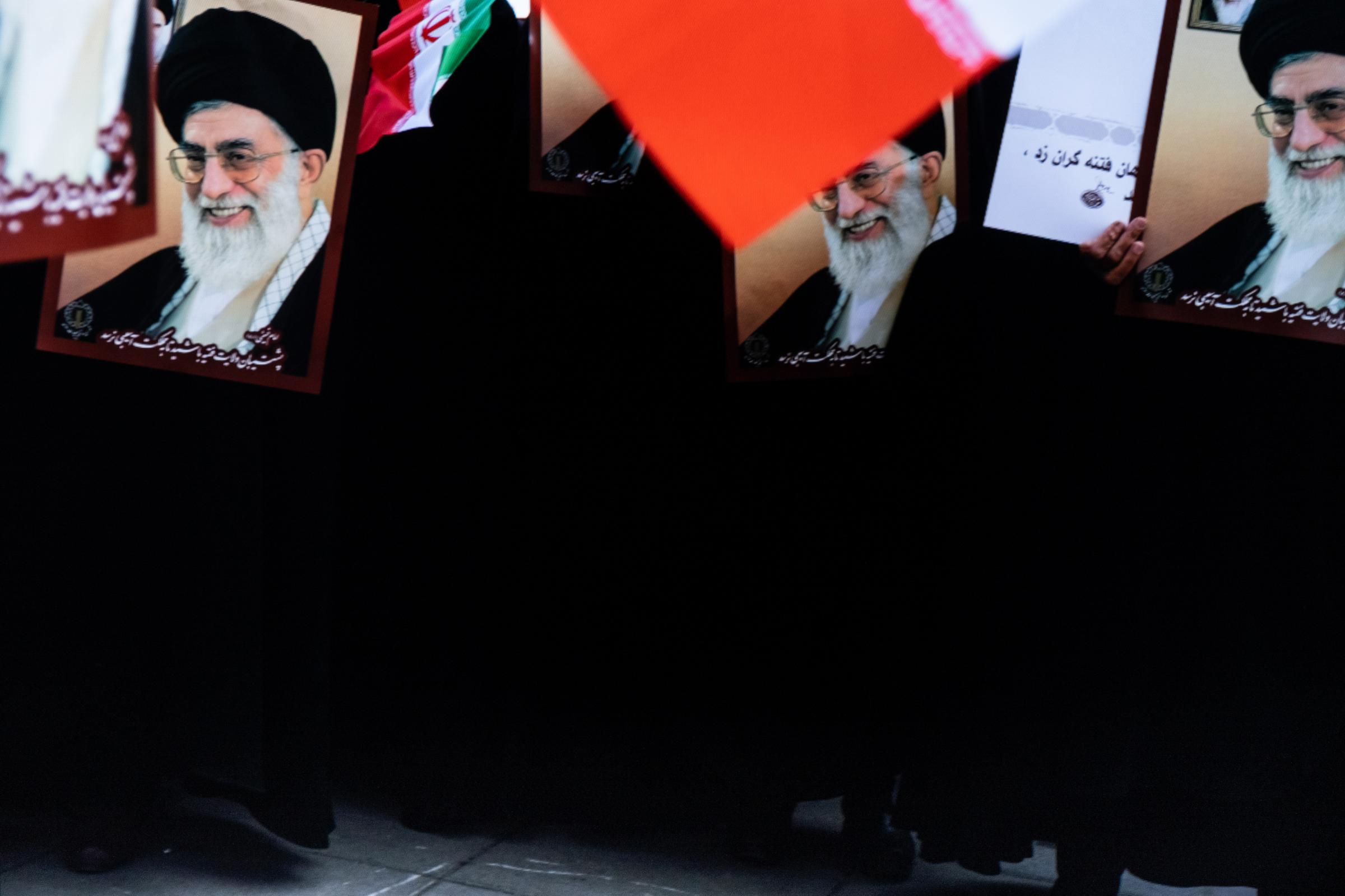 Iran. Rasht, 19 December 2020 - Women holding the portrait of Iran&#39;s supreme leader Ali Khamenei at Pro-government protestors at a rally....