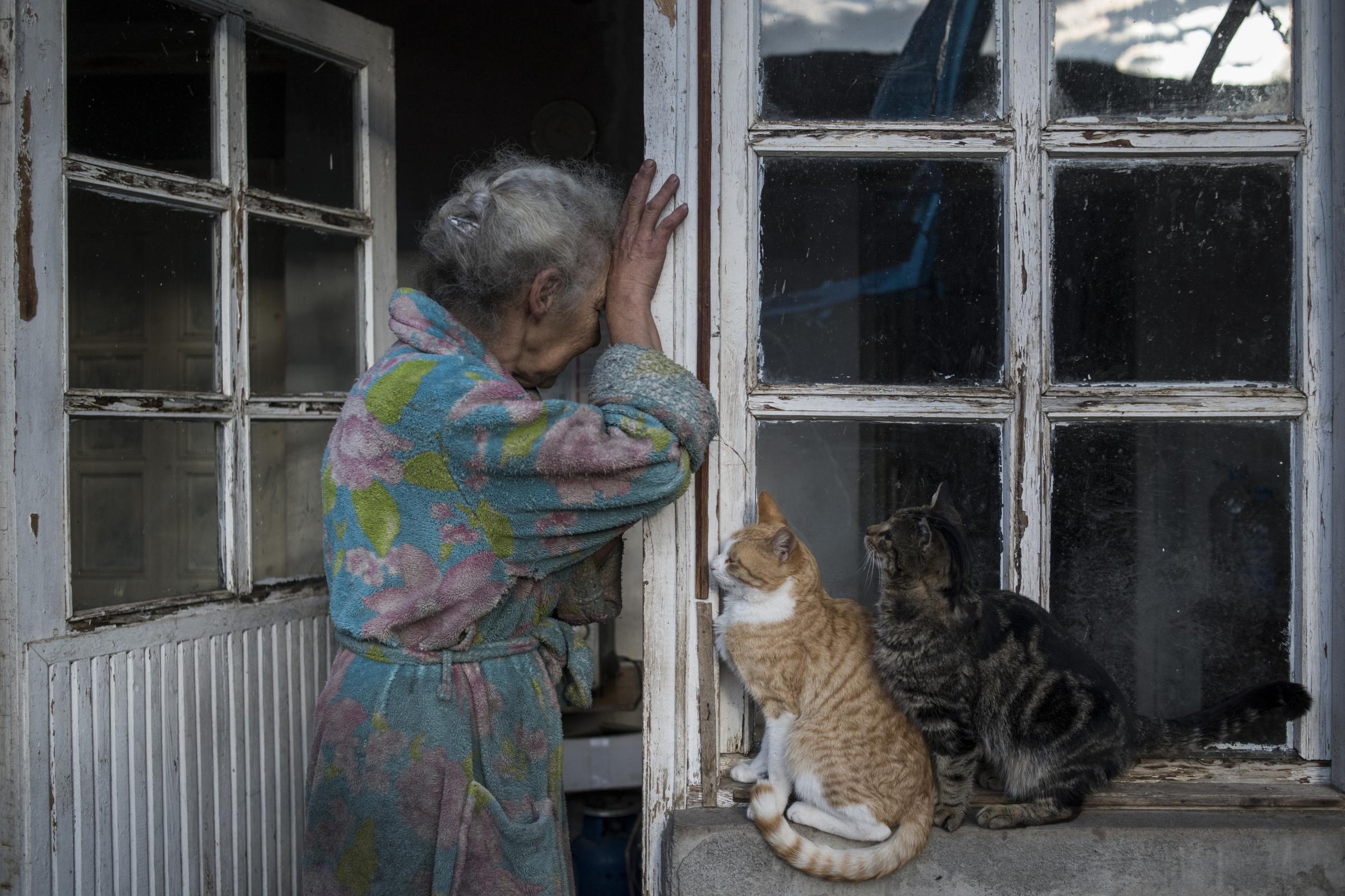 Paradise Lost - Abovyan Hasmik  (69) cries at the door of her house in the village of Nerkin Sus, Nagorno-Karabakh

