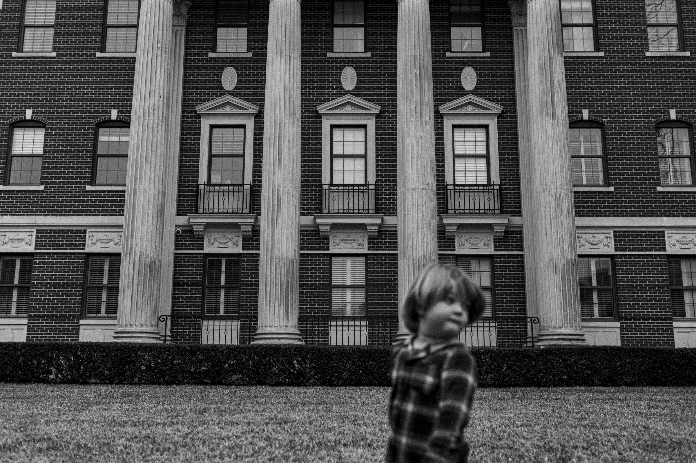 A young child wonders the grounds of Baylor University in Waco, Texas, 01/08/2022. A rainy day in Waco sets the mood of the empty campus at Baylor. As the pandemic continues the youths untold stories of the pandemic still lie hidden.