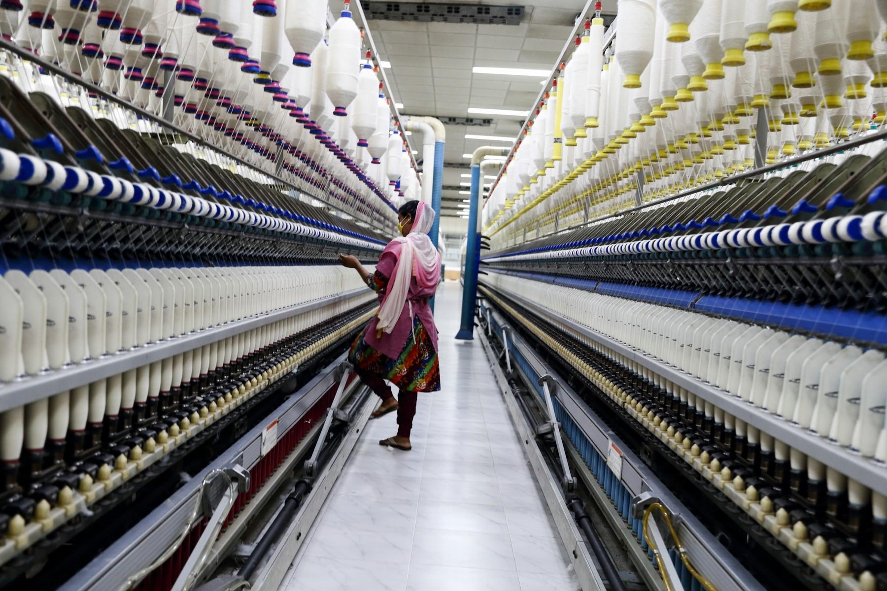 A textile worker is operating in the spinning of yarn section inside DBL factory. Asulia, Bangladesh