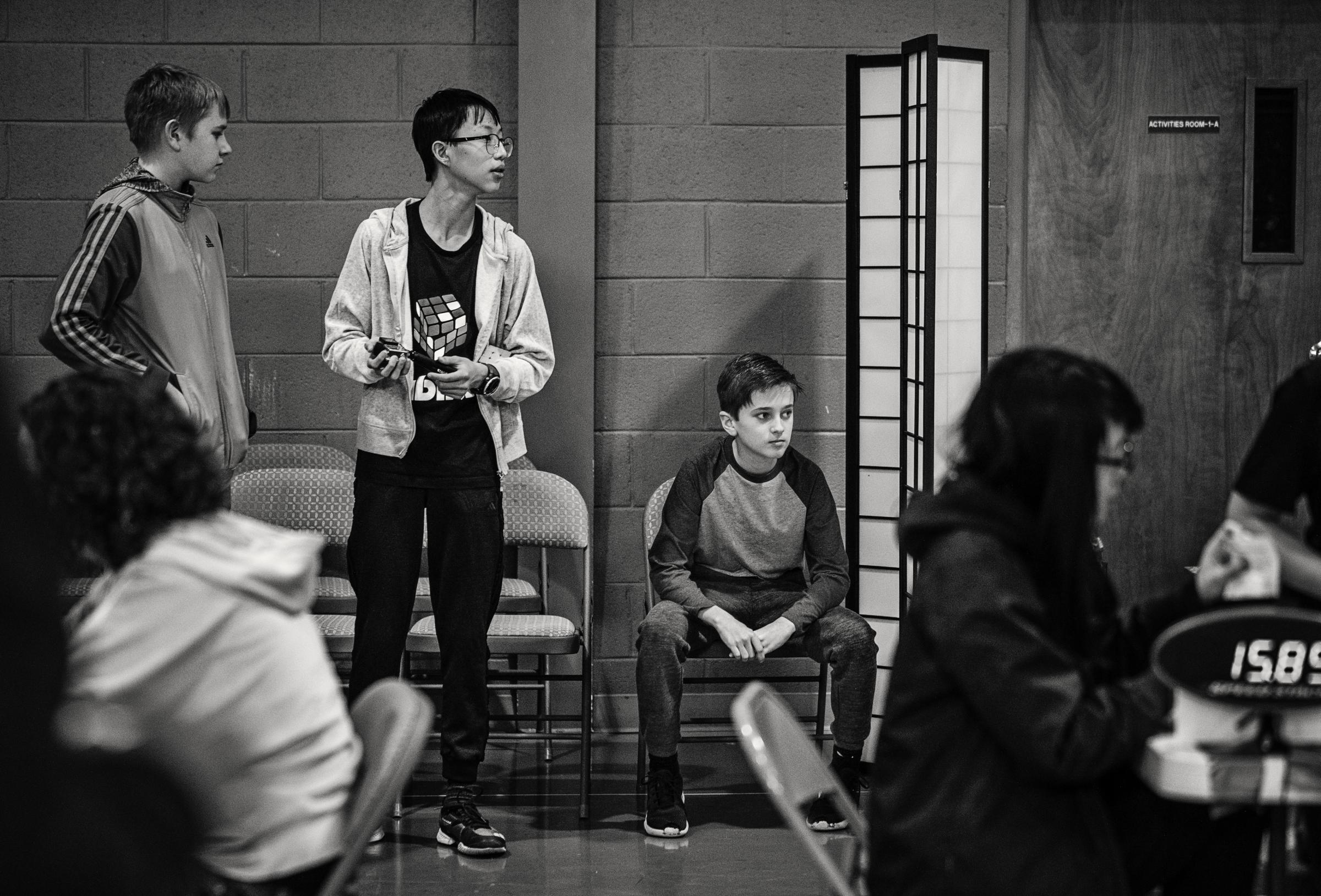 Speedcubers - Competitors wait &quot;on deck&quot; between rounds while their cubes are being...