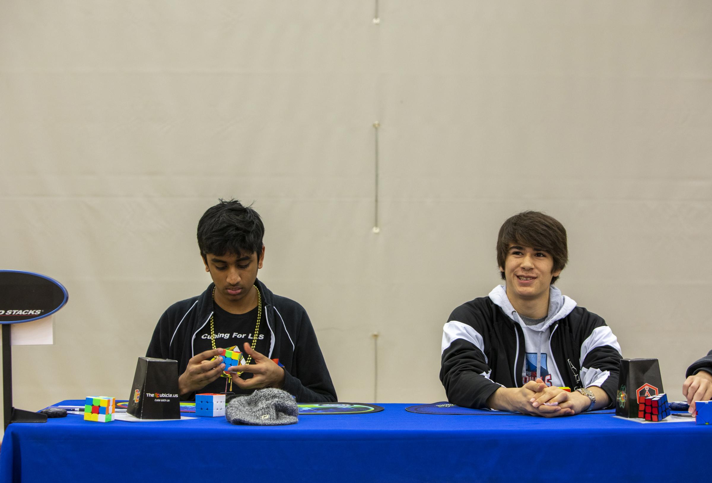 Speedcubers - The competitor on the right uses hand warmers between solves to help keep his fingers moving...