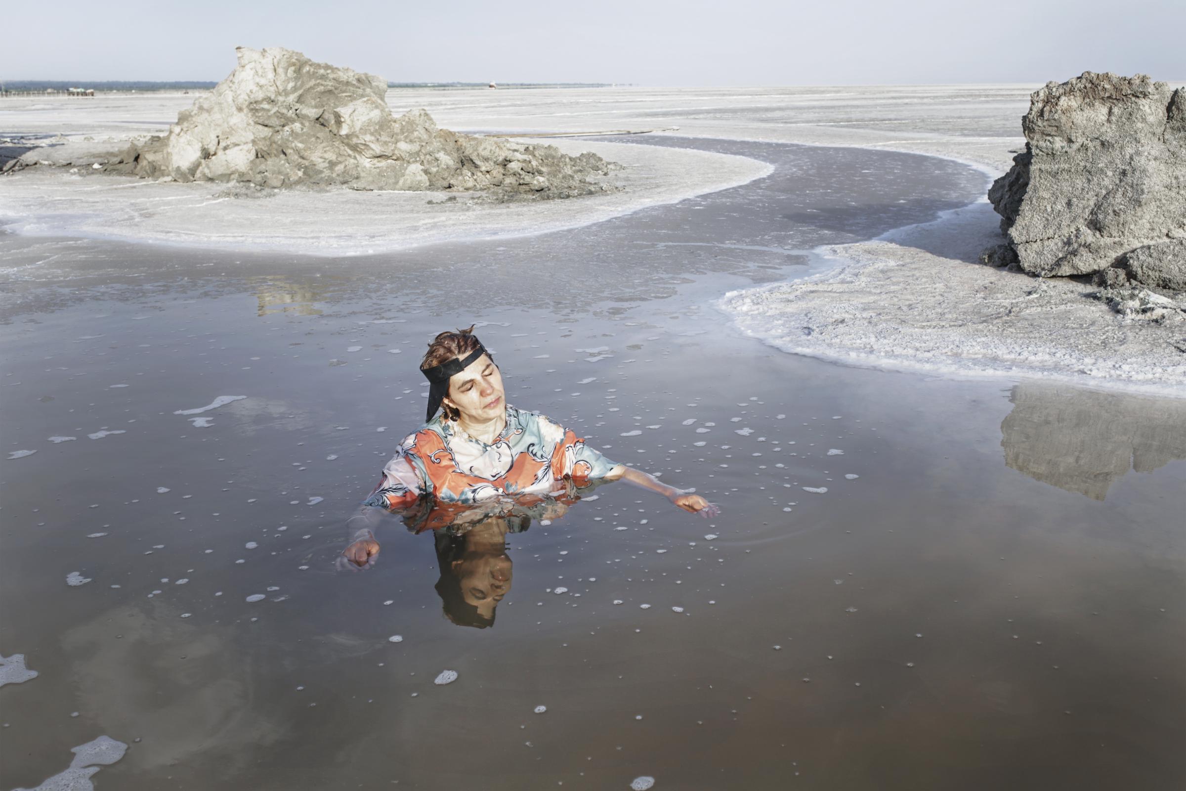 THE EYES OF EARTH (THE DEATH OF LAKE URMIA 2014-ONGOING) -   My mother swims in a shallow pond that is a remnant of...