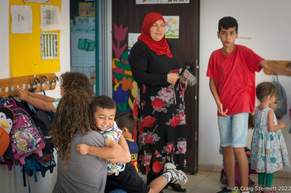 KAFR QARA, ISRAEL-MAY 30: Kindergarden teacher Daisy Yaakov gets a hug from student Bashar Abu Fane at the Wadi Ara Hand in Hand School, Kafr Qara, Israel on May 30th, 2016. The Hand in Hand educational School concept was given birth in 1997 by Amin Khalaf, an Arab teacher and lecturer, and Lee Gordon, a Jewish-American social activist, after they met while working in their respective fields promoting Arab-Jewish dialogue in Israel. The schools they pioneered host an equal number of Jewish and Arab students respectively. Two teachers simultaneously in both Arabic and Hebrew teach the lessons. Judaism, Islam and also Christianity are taught with equal weight to all students, and each faith&rsquo;s respective religious holidays are also observed. Emphasis is given not only to one&rsquo;s own culture and language but also to those of the &quot;other&quot;. The children study two accounts of history: the creation of the &quot;Jewish homeland&quot; as well as the narrative of the Palestinian struggle. (Photo by Craig Stennett/Getty Images)