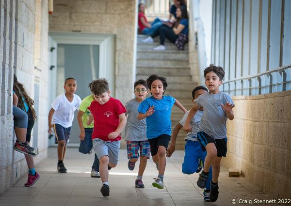 JERUSALEM, ISRAEL-JUNE 01: Arab and Jewish Israeli children playing together during break time in the corridors of the mixed religion Hand in Hand School in Jerusalem, Israel on June 1st, 2016.. The Hand in Hand educational School concept was given birth in 1997 by Amin Khalaf, an Arab teacher and lecturer, and Lee Gordon, a Jewish-American social activist, after they met while working in their respective fields promoting Arab-Jewish dialogue in Israel. The schools they pioneered host an equal number of Jewish and Arab students respectively. Two teachers simultaneously in both Arabic and Hebrew teach the lessons. Judaism, Islam and also Christianity are taught with equal weight to all students, and each faith&rsquo;s respective religious holidays are also observed. Emphasis is given not only to one&rsquo;s own culture and language but also to those of the &quot;other&quot;. The children study two accounts of history: the creation of the &quot;Jewish homeland&quot; as well as the narrative of the Palestinian struggle. (Photo by Craig Stennett/Getty Images)