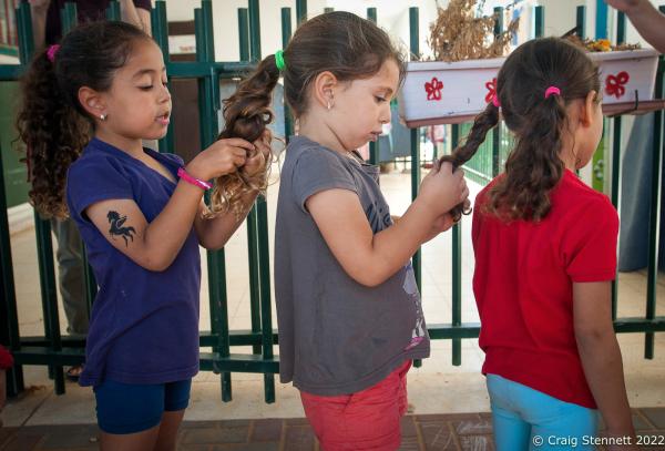 KAFR QARA, ISRAEL-MAY 30: Wadi Ara Kindergarden students Lor Sawalha, Aline Kitane, Duna Gawi getting ready to go out into the main playground at Wadi Ara, Hand in Hand School, Kafr Qara, Israel on May 30th, 2016. The Hand in Hand educational School concept was given birth in 1997 by Amin Khalaf, an Arab teacher and lecturer, and Lee Gordon, a Jewish-American social activist, after they met while working in their respective fields promoting Arab-Jewish dialogue in Israel. The schools they pioneered host an equal number of Jewish and Arab students respectively. Two teachers simultaneously in both Arabic and Hebrew teach the lessons. Judaism, Islam and also Christianity are taught with equal weight to all students, and each faith&rsquo;s respective religious holidays are also observed. Emphasis is given not only to one&rsquo;s own culture and language but also to those of the &quot;other&quot;. The children study two accounts of history: the creation of the &quot;Jewish homeland&quot; as well as the narrative of the Palestinian struggle. (Photo by Craig Stennett/Getty Images)