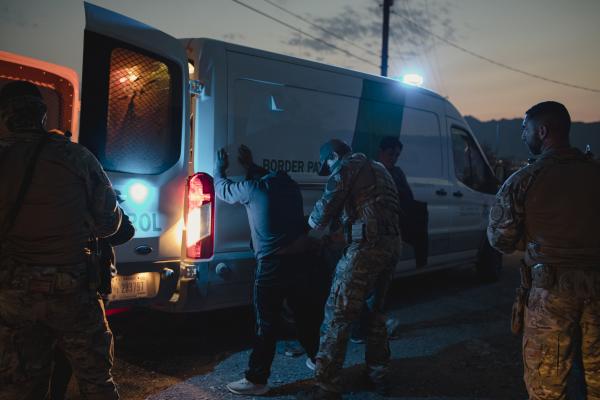 An agent with the Border Patrol Search, Trauma, and Rescue Unit (BORSTAR) search migrants after apprehending them near Mount Cristo Rey in Sunland Park, NM on July 21, 2021.