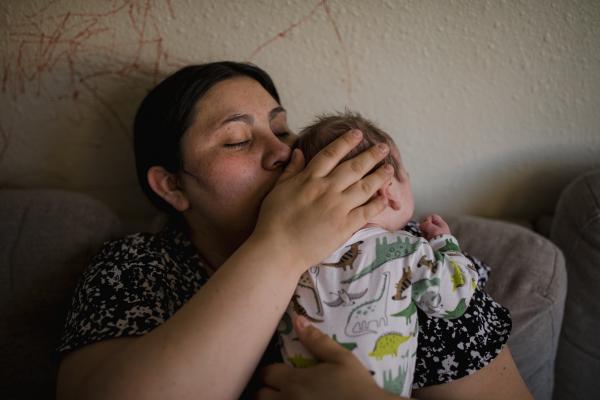 Image from Singles - Alyssa Davis holds her infant son at her apartment in...